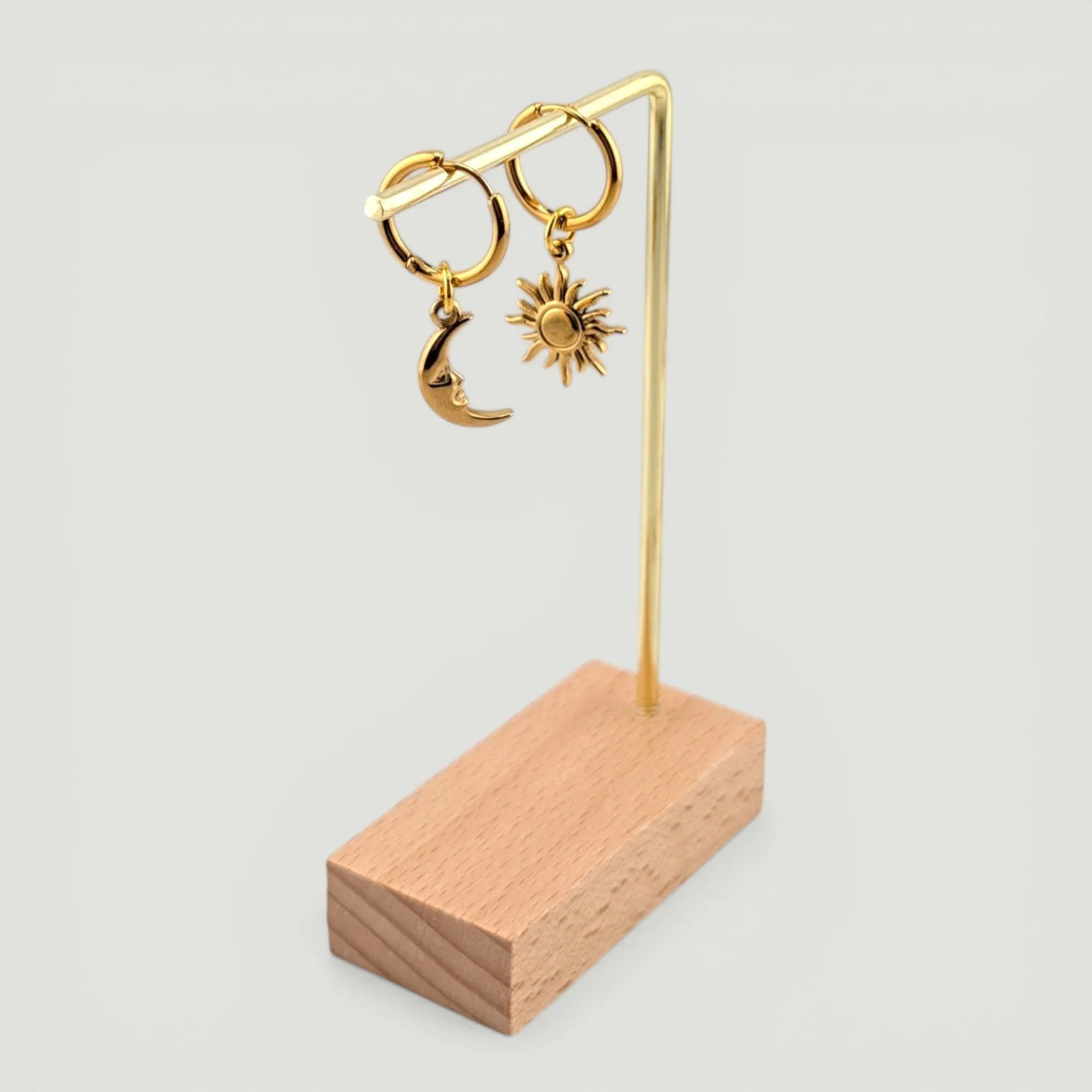 Sun & moon stainless steel huggie earrings hanging on display full drop gold