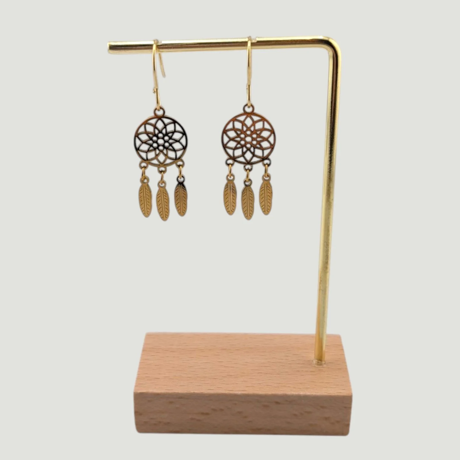 Dreamcatcher stainless steel drop earrings, gold, on earring stand, drop view