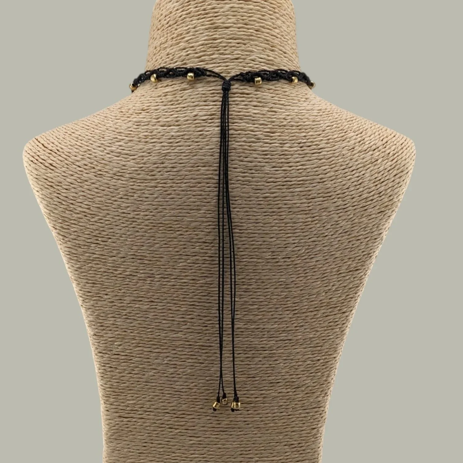 rear view of bull skull woven macrame choker showing adjustable sliding cord and back drape