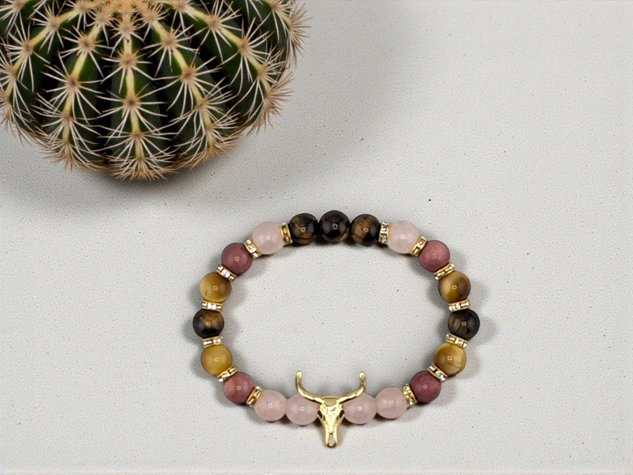 Pink and gold beaded western bracelet with gold bull skull and rhinestone spacers