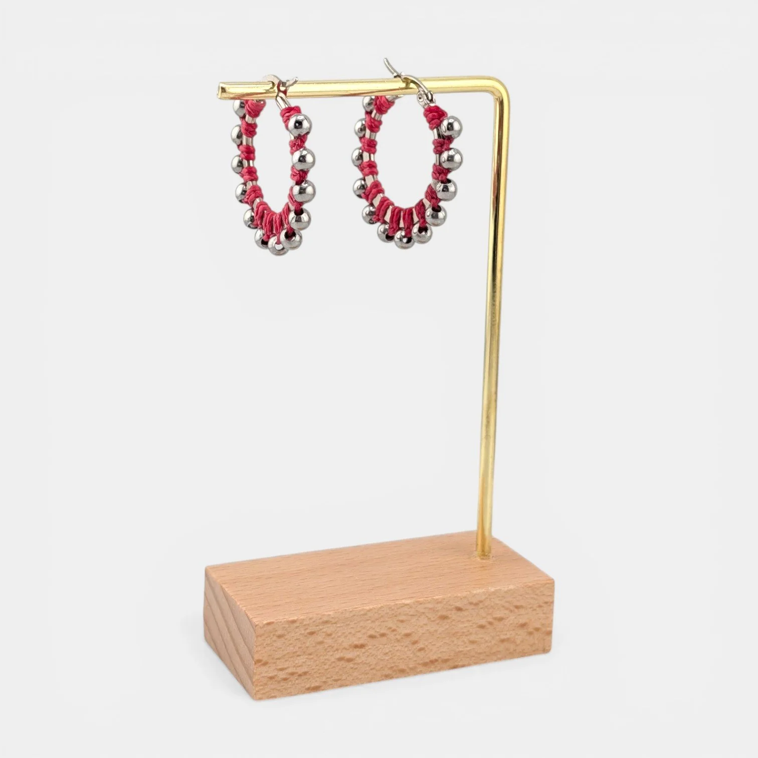 Pink beaded macramé stainless steel hoop earrings in silver, 30 mm drop shown on earring display stand