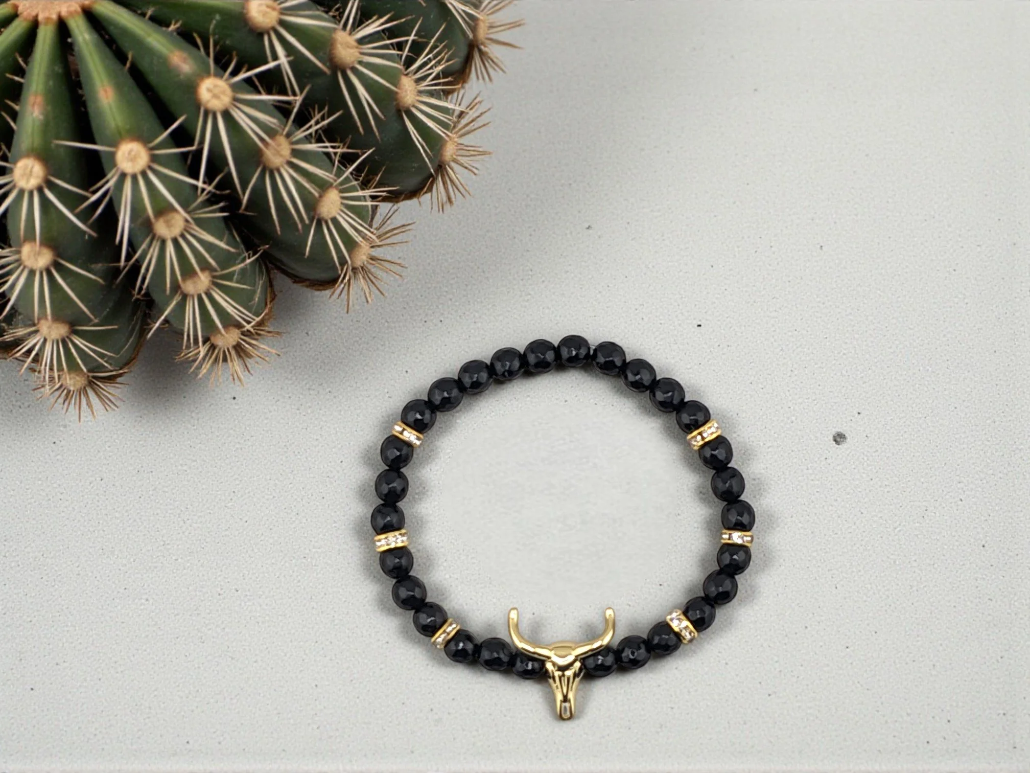Black onyx golden bull skull beaded bracelet with small delicate beads and golden rhinestone spacers