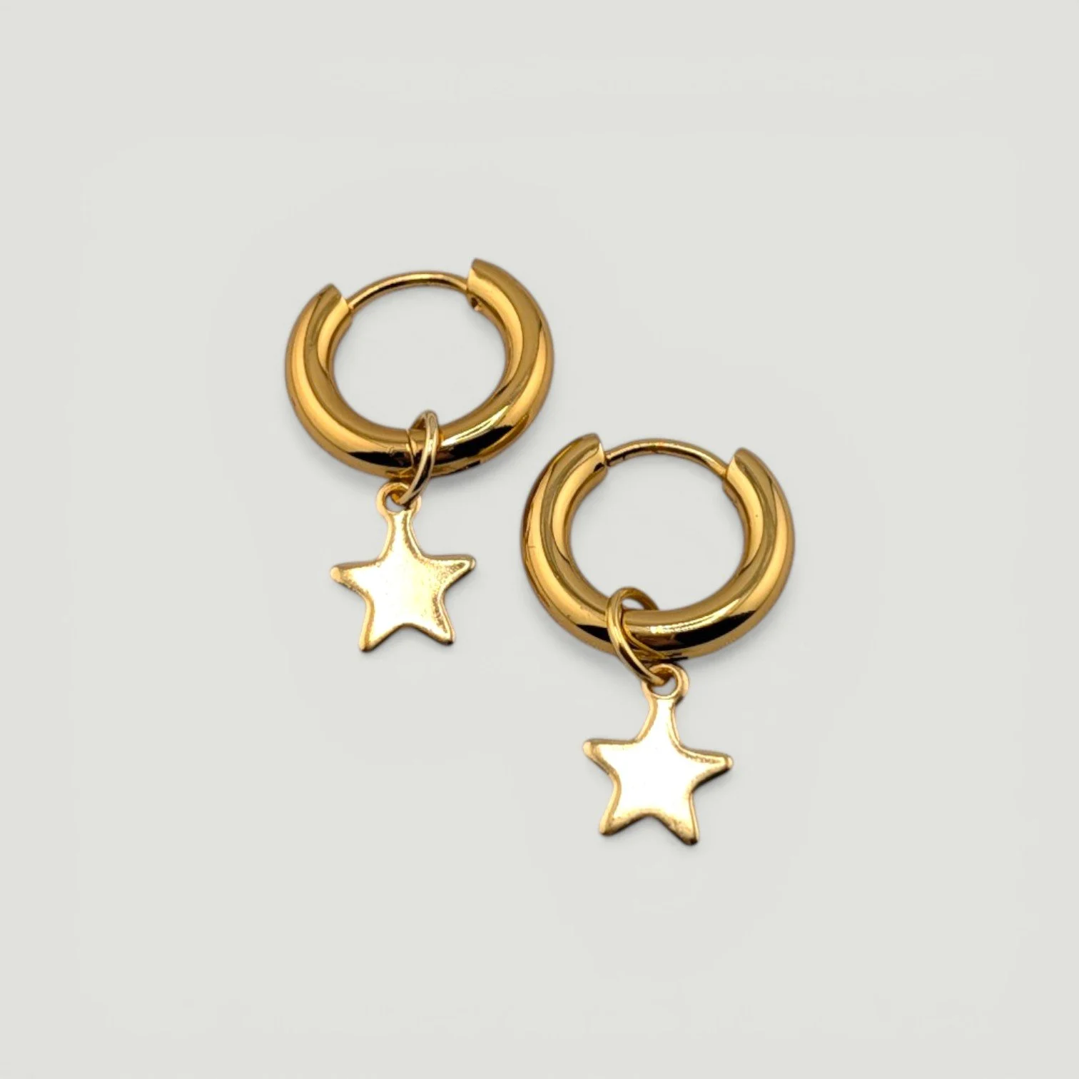 star stainless steel huggie hoop earrings, gold, flat lay