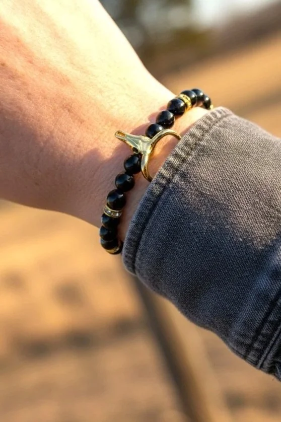 women wearing a dainty black onyx beaded bull skull bracelet