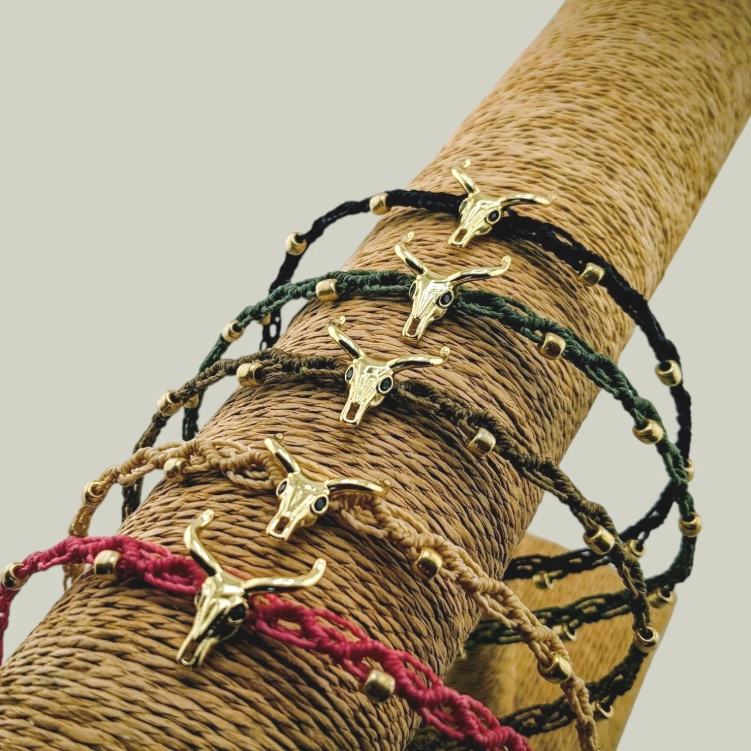 Bull skull western woven macrame chokers displayed on a t-bar stand showing the five available colors