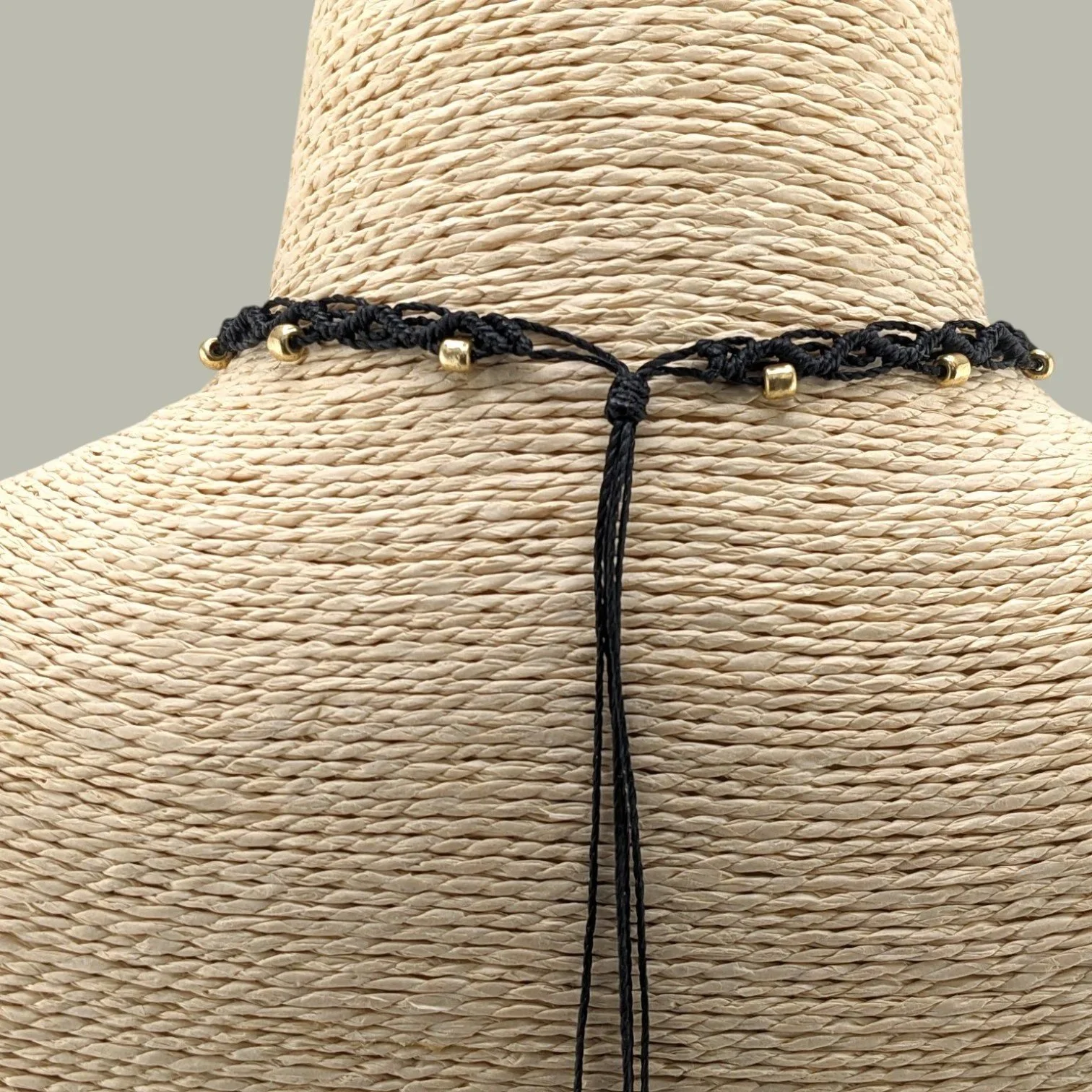 Back view close-up of macrame choker sliding knot closure showing adjustable cord design