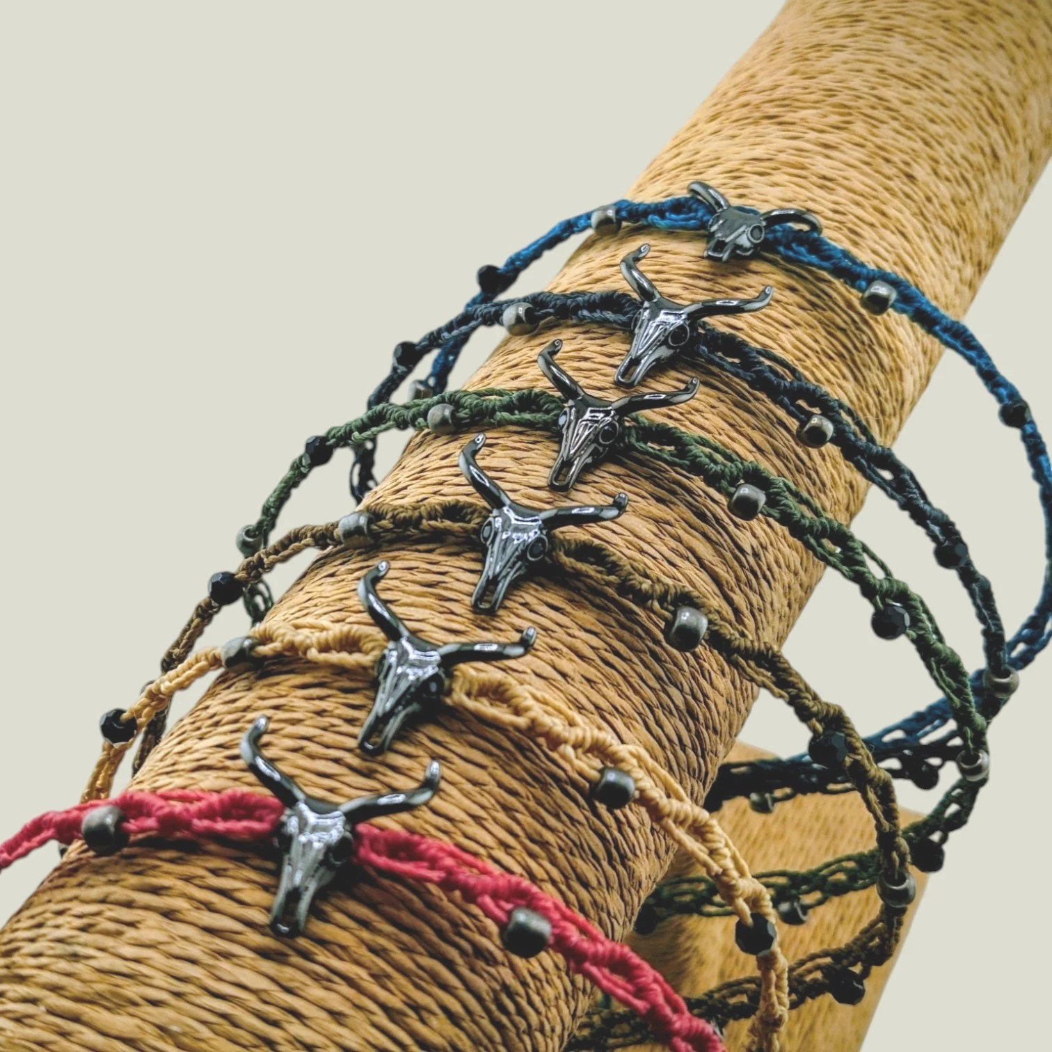 Bull skull western woven chokers displayed on a t-bar stand showing six available colors