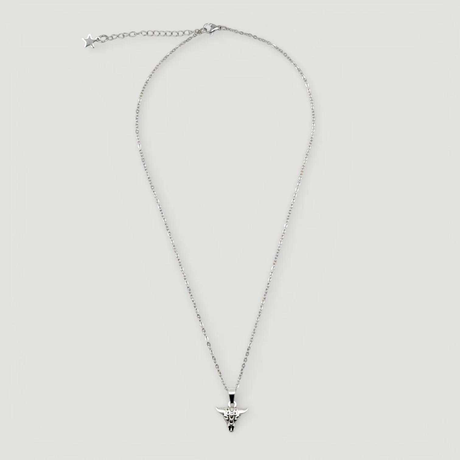bull skull pendant on a silver stainless chain, full flat lay