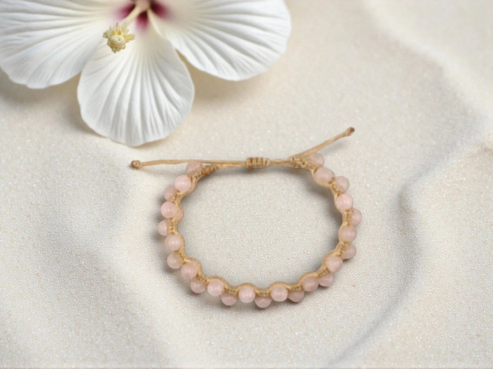 a view from above of an adjustable rose quartz macramé bracelet