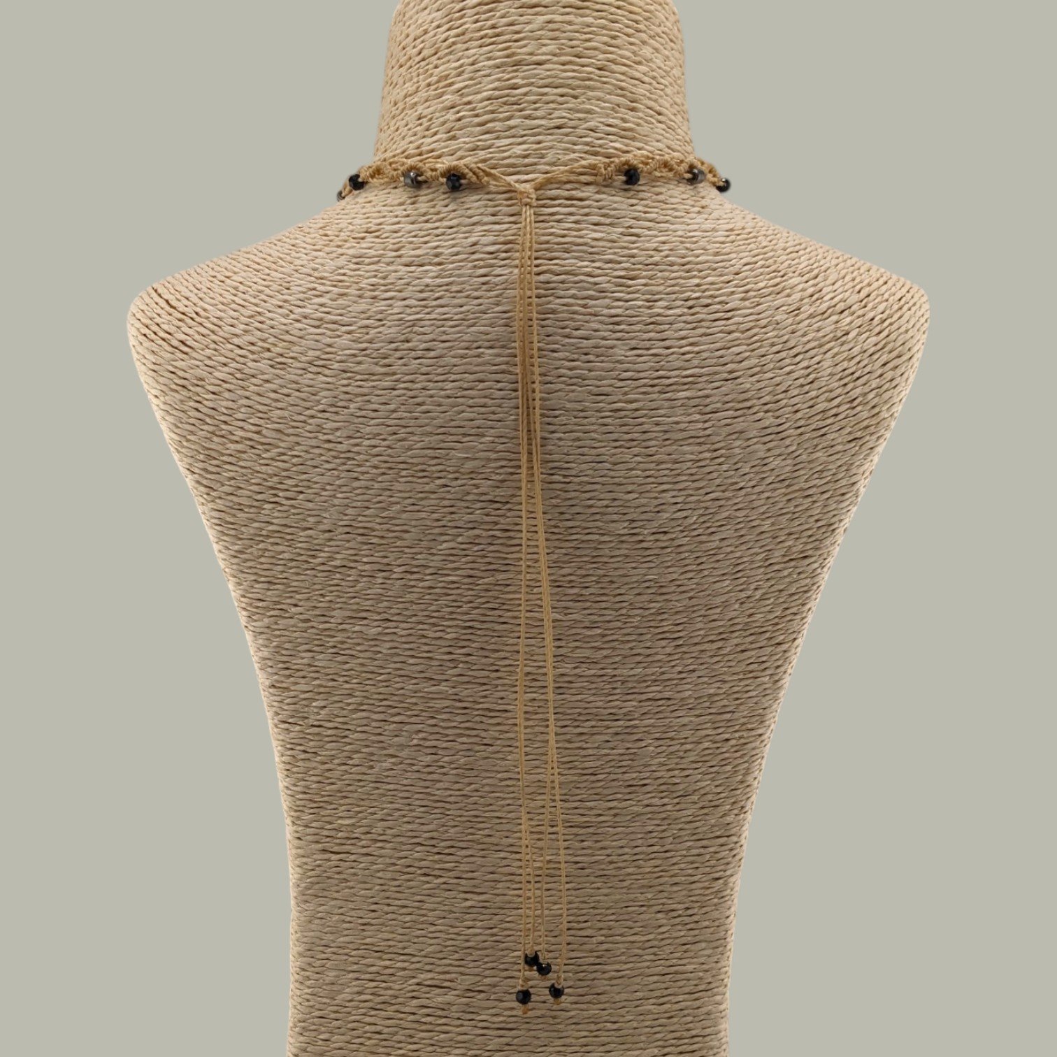 Rear view of bull skull macrame choker showing adjustable sliding cord and back drape