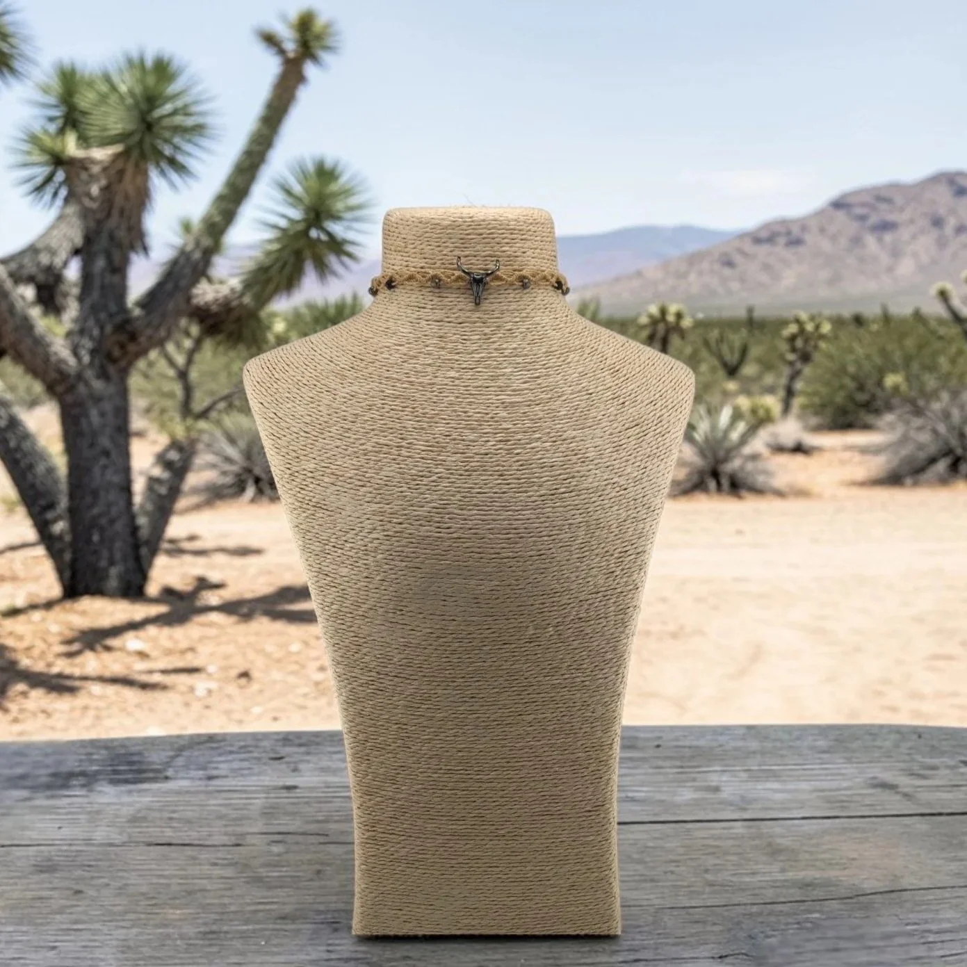 Front view of bull skull woven macrame choker displayed on a bust in a western styled setting