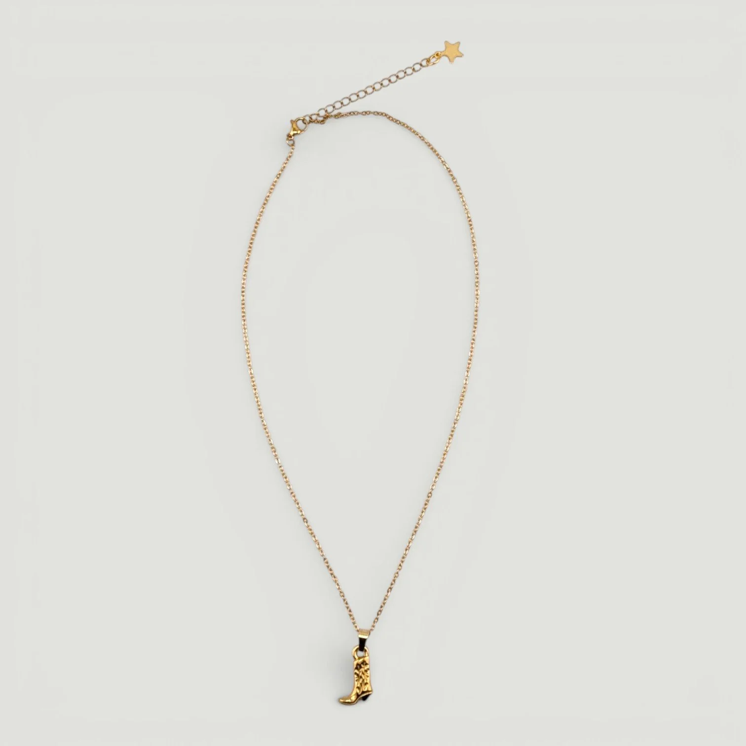 gold stainless steel cowboy boot necklace full chain flat lay