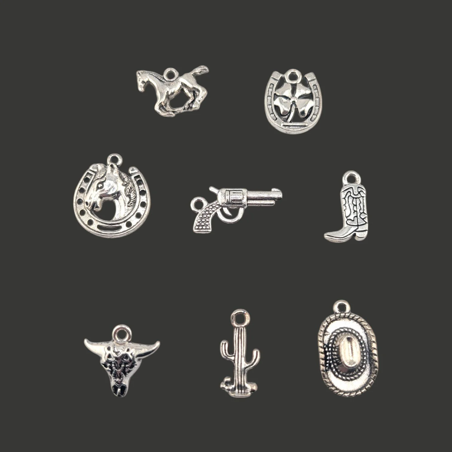 choice of eight distinct silver-tone  western charms on a black background