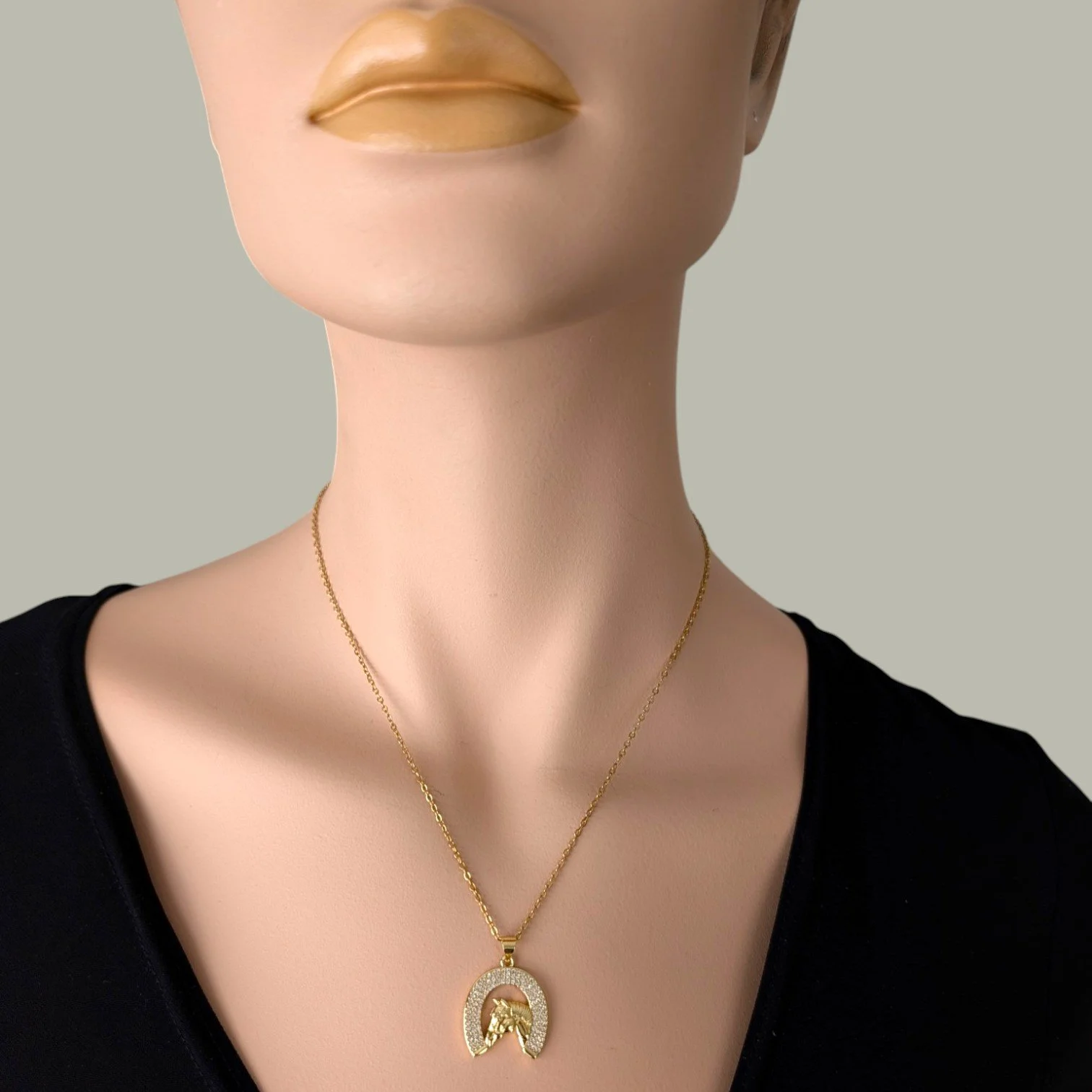 Rhinestone horseshoe horse gold stainless steel necklace worn on mannequin, close up bust view