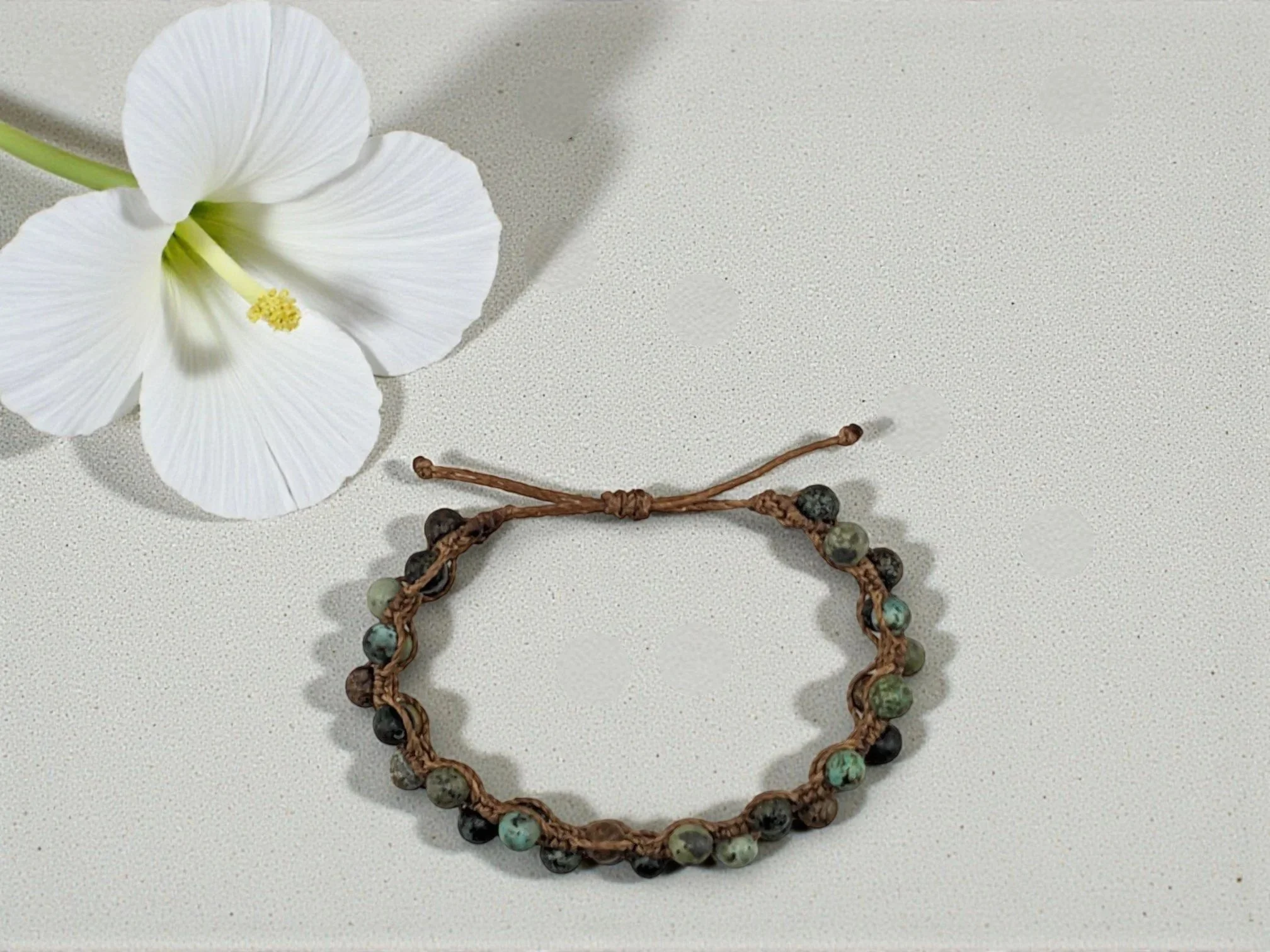 a view from above of an adjustable macramé african turquoise bracelet