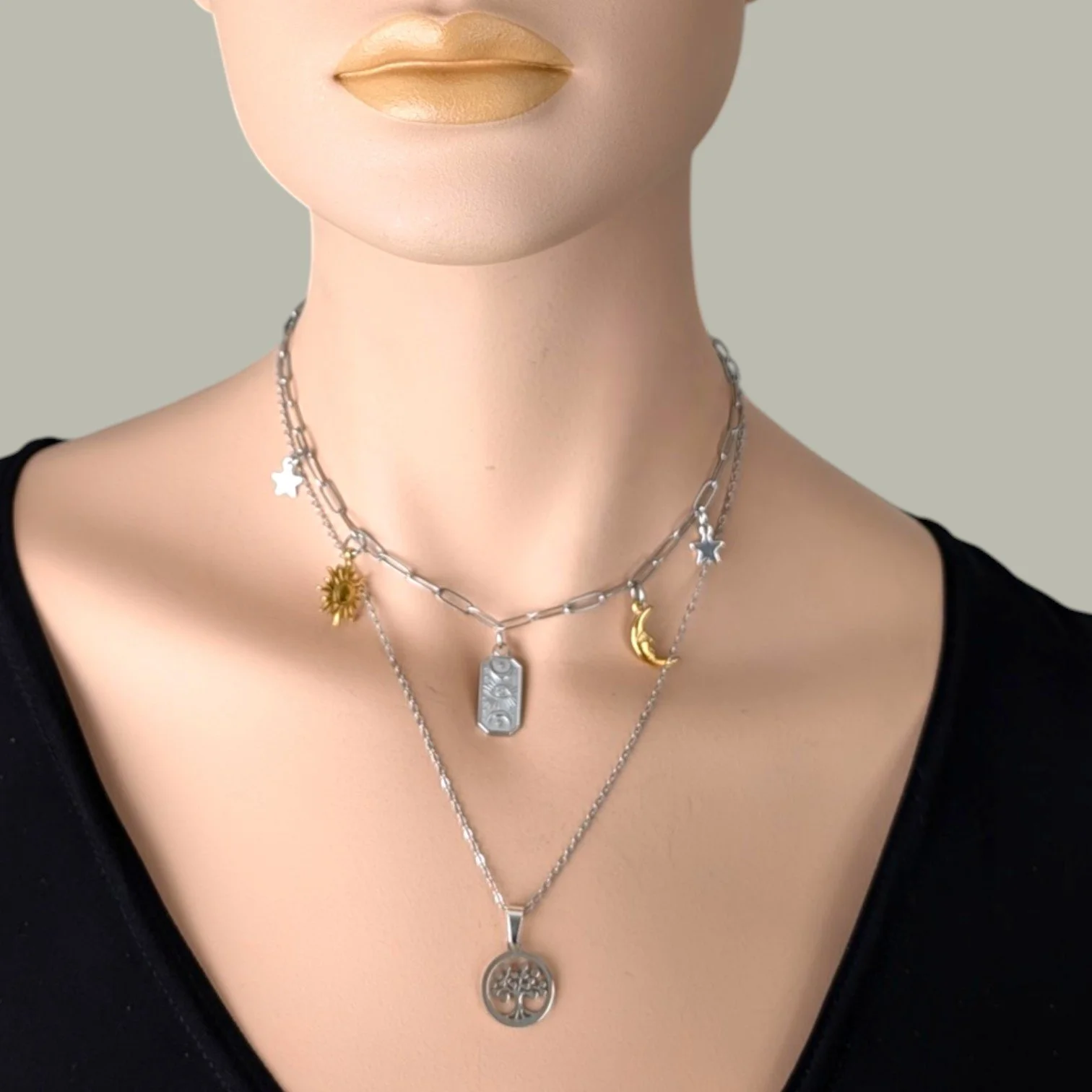 tree of life silver stainless steel necklace layered with celestial charm necklace on mannequin bust close-up