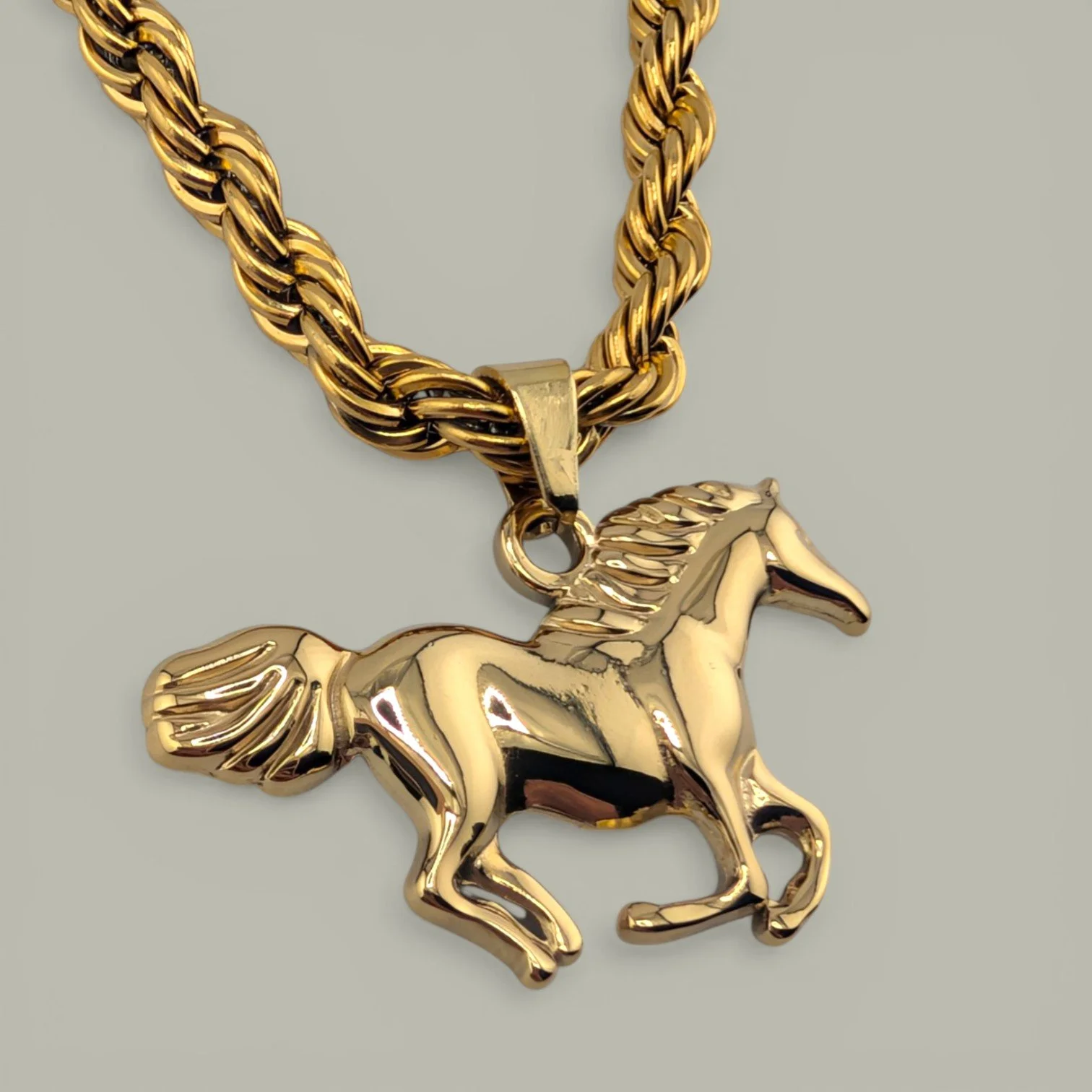 horse pendant gold stainless steel close up detail