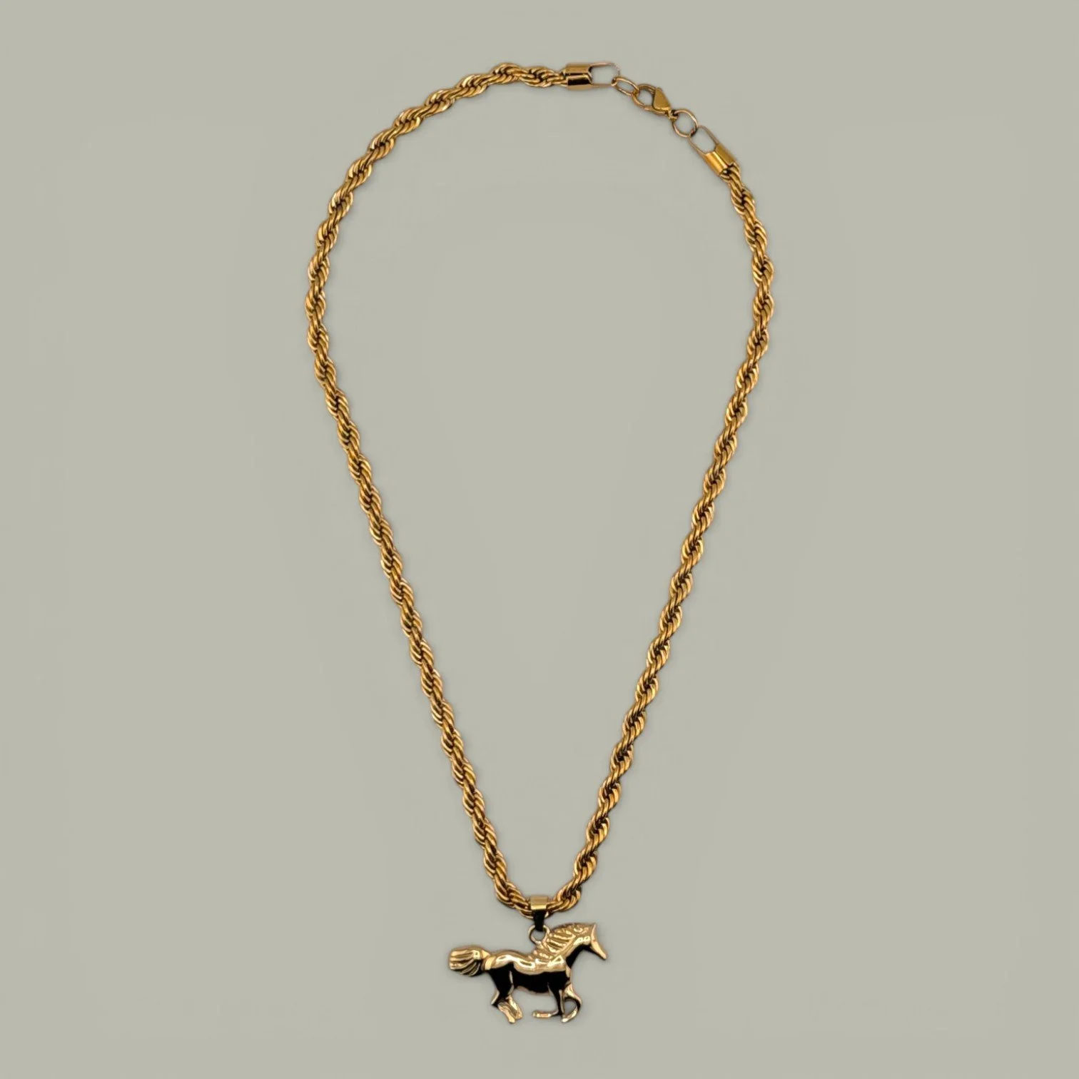 chunky horse gold stainless steel statement necklace full view flat lay
