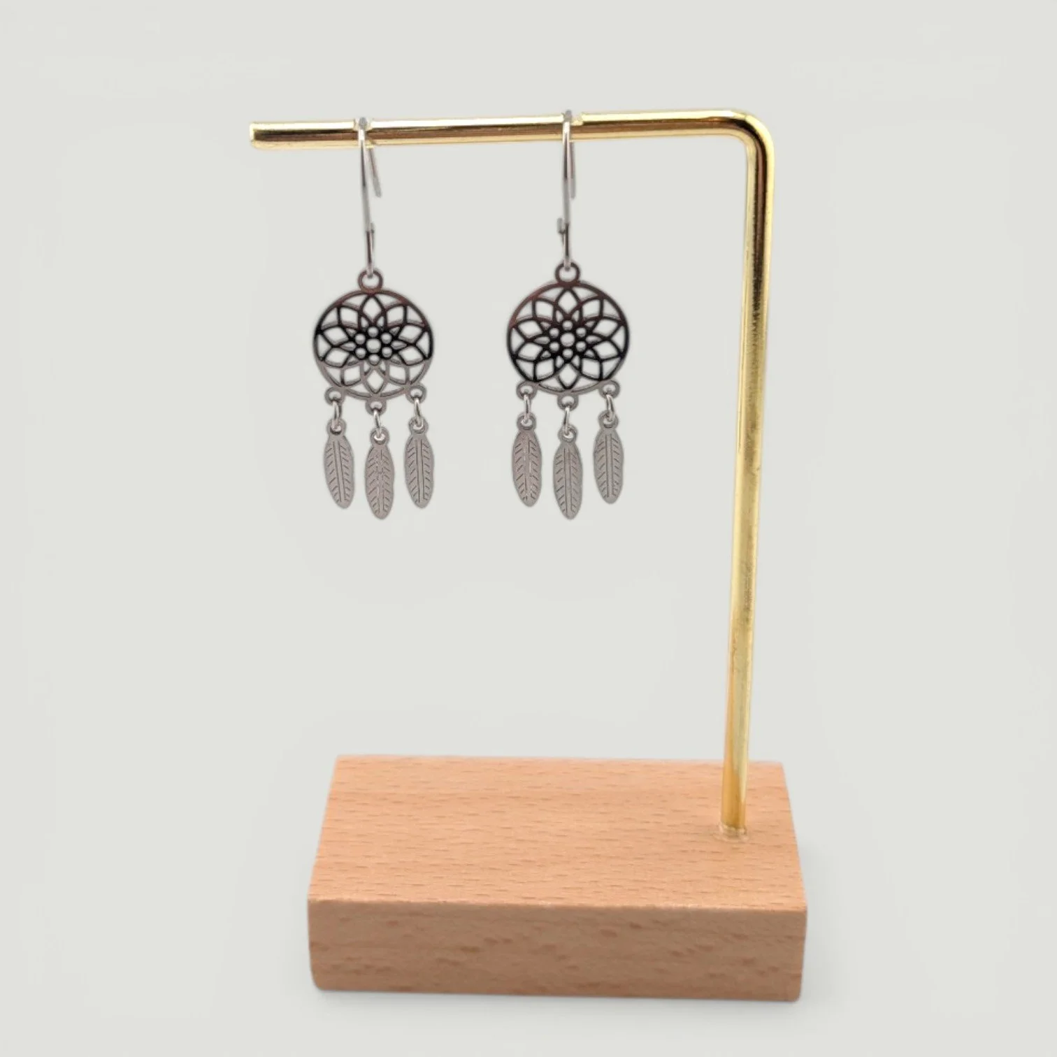 Dreamcatcher stainless steel drop earrings, silver, on earring stand, drop view