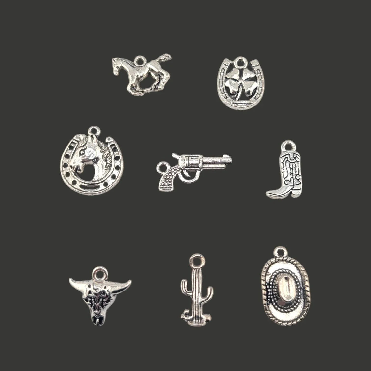 choice of eight distinct silver-tone  western charms on a black background