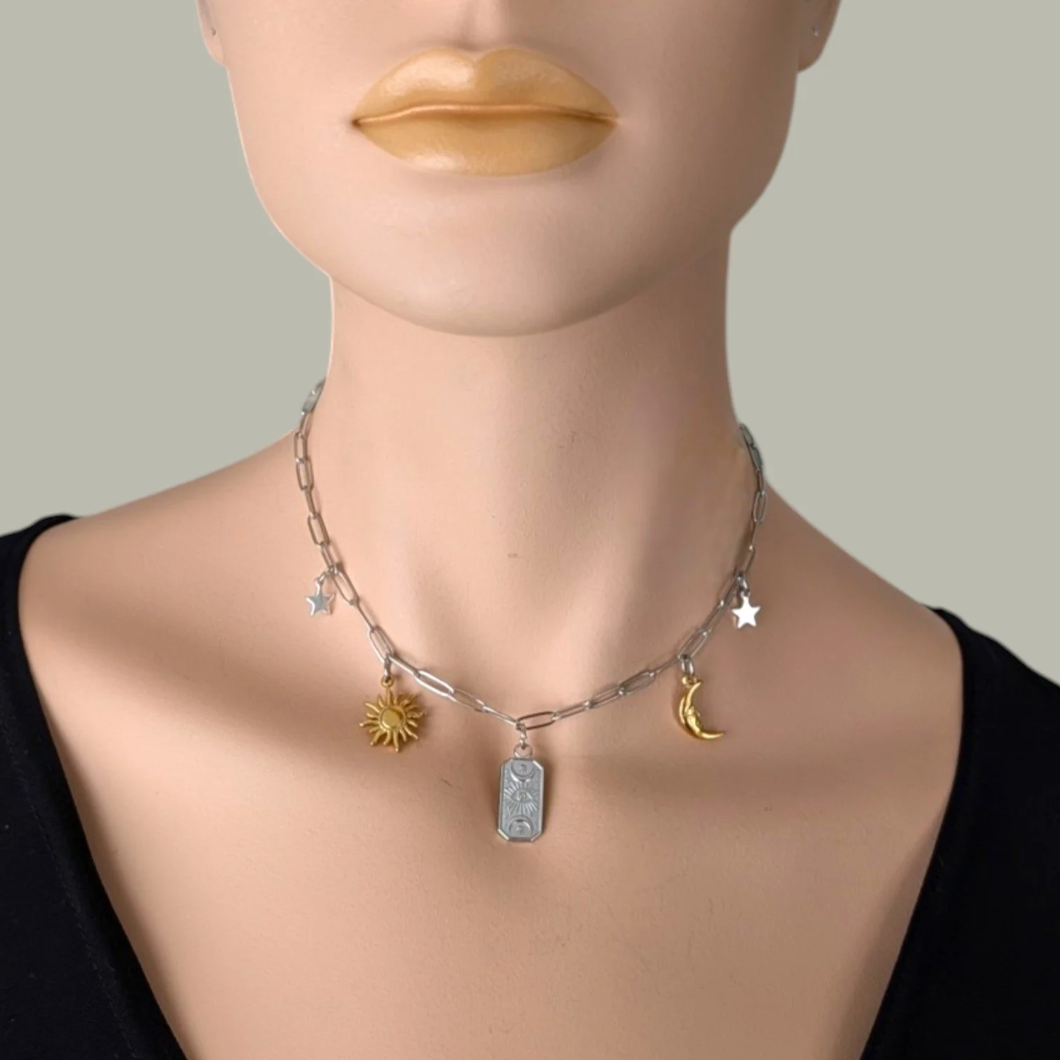 Silver two-tone evil eye celestial stainless steel charm necklace on mannequin, close up bust view