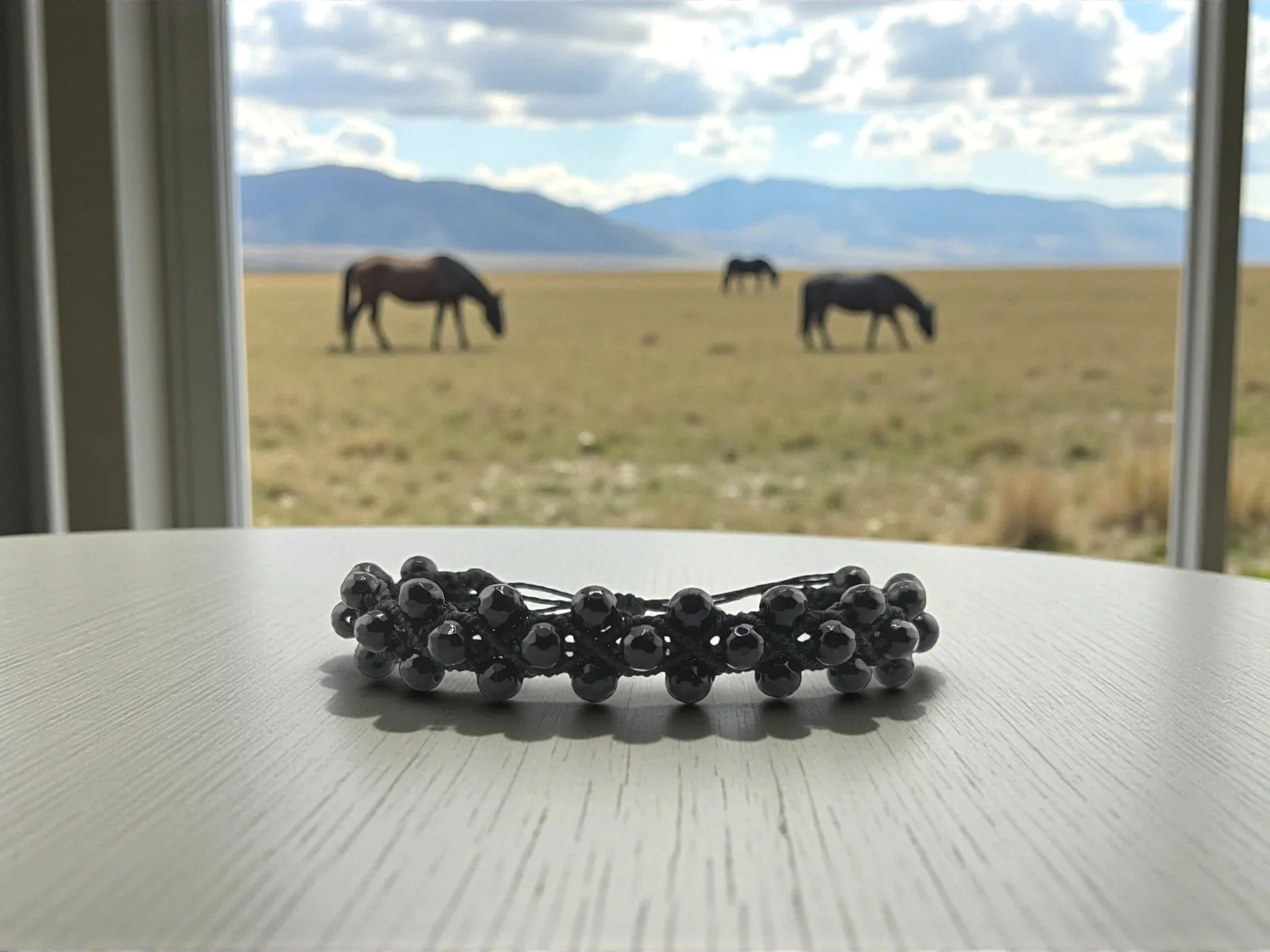 Black onyx macramé bracelet on a table