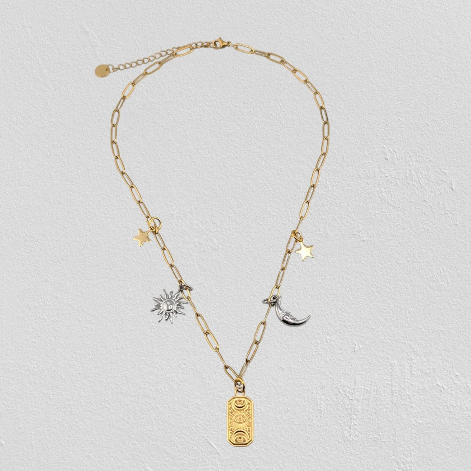 Gold two-tone evil eye celestial stainless steel charm necklace full view flat lay