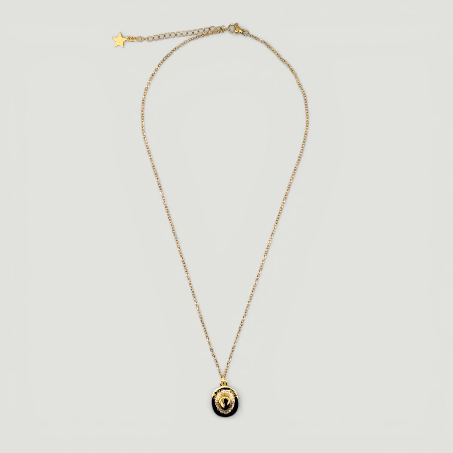 rhinestone cowboy hat necklace on a gold stainless steel chain, full flat lay