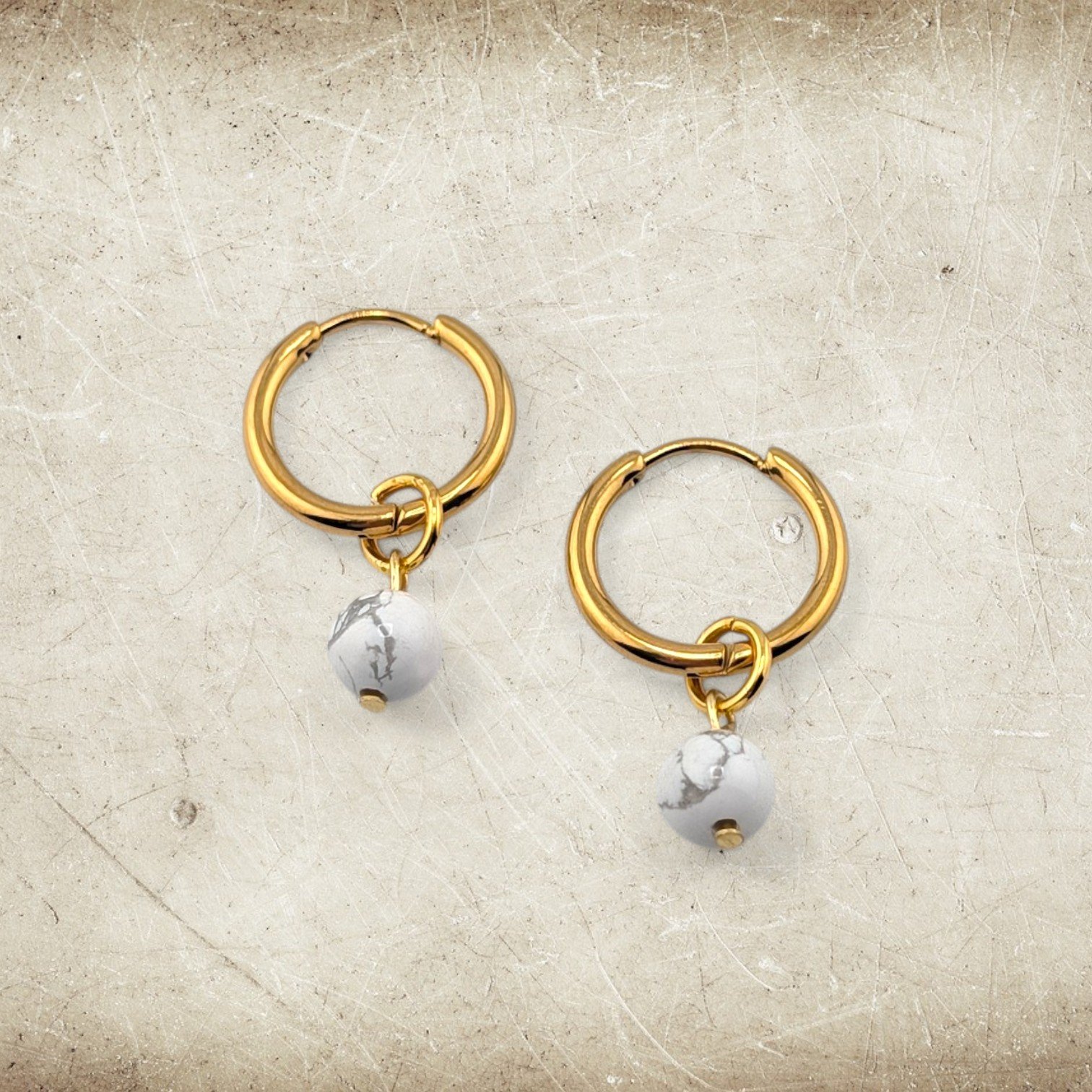 Howlite bead huggie hoop earrings with stainless steel hoops, minimal look flat lay