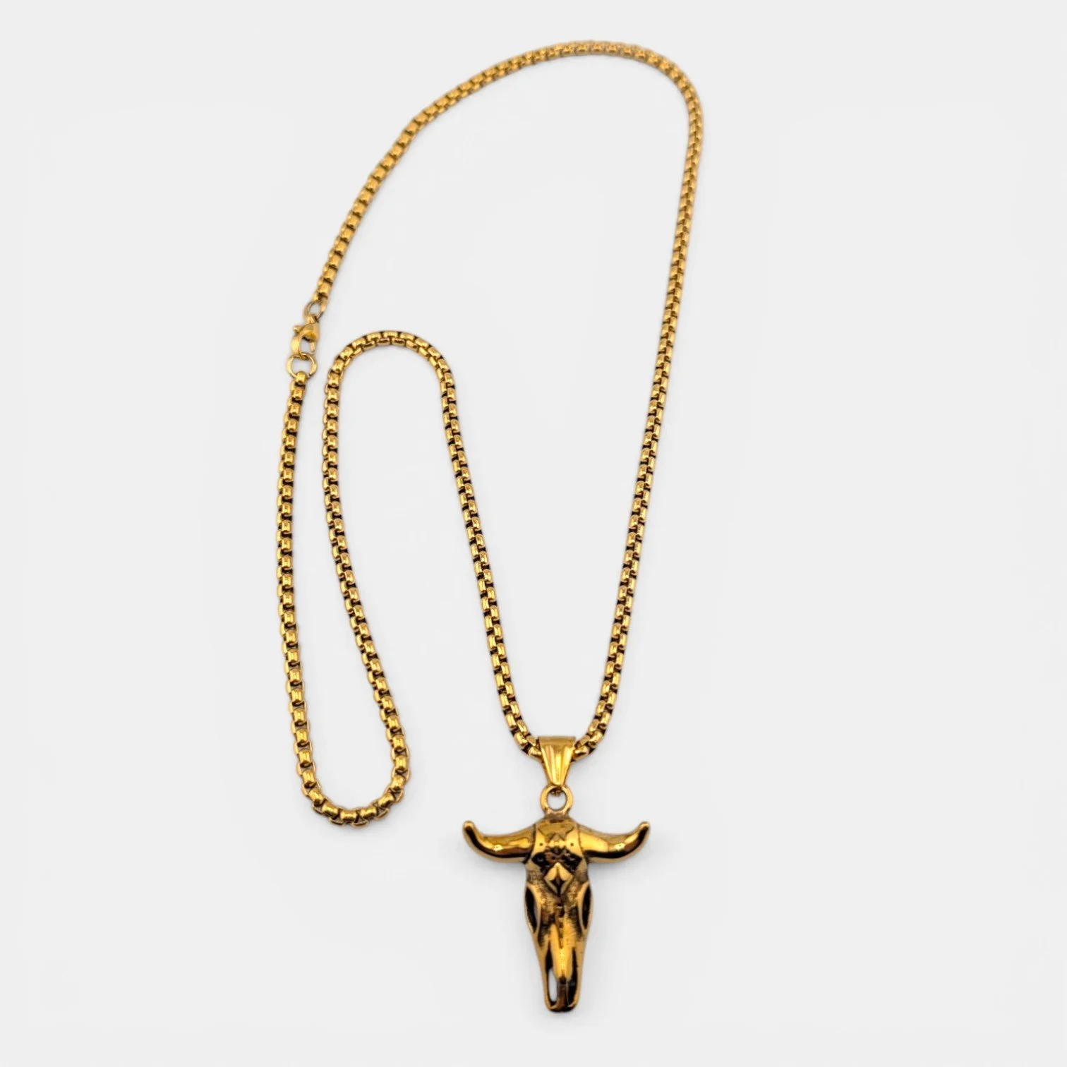 men's bull skull gold stainless steel necklace full view flat lay showing 3mm box chain and pendant