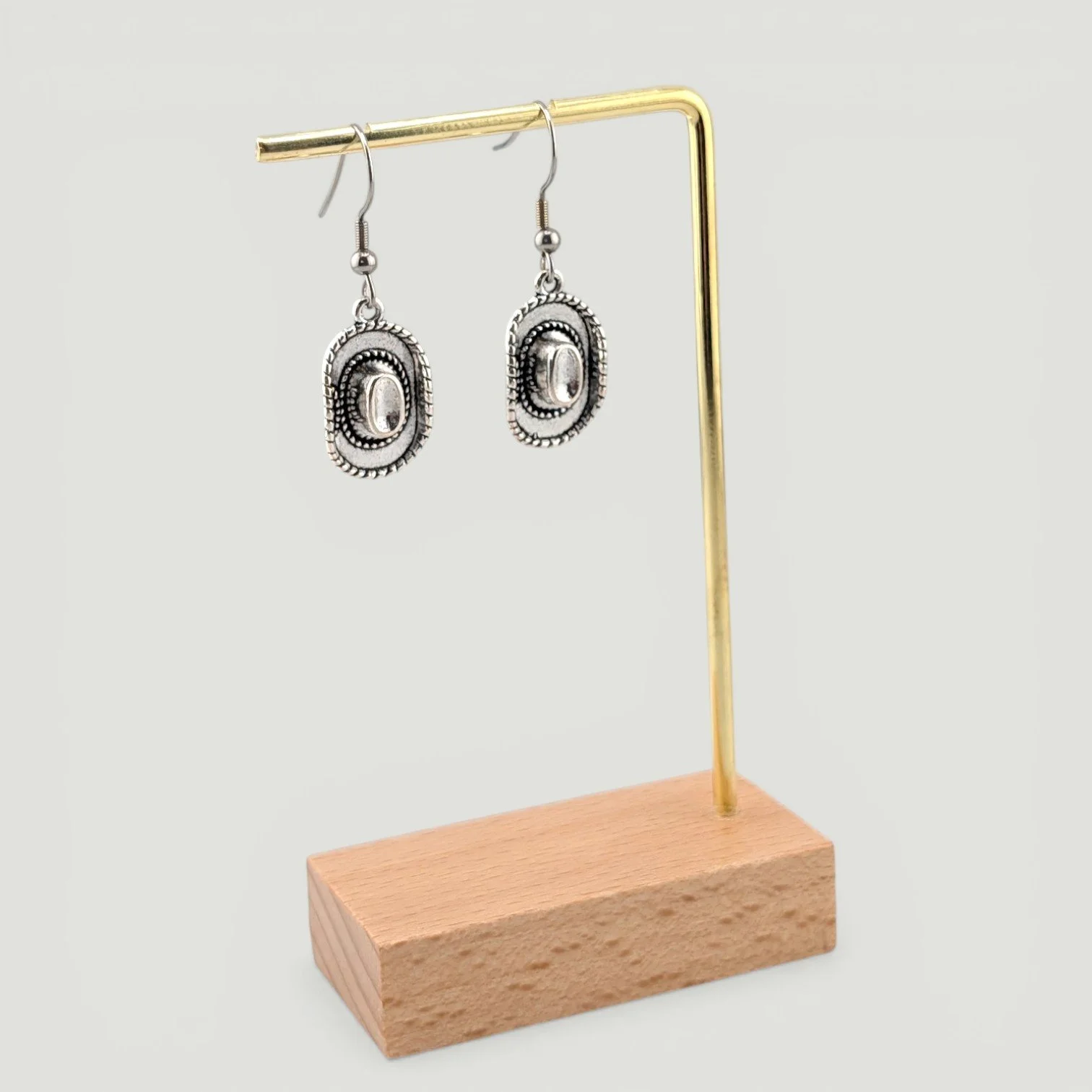 Cowboy hat drop earrings on display stand showing full drop length, silver tone Western earrings