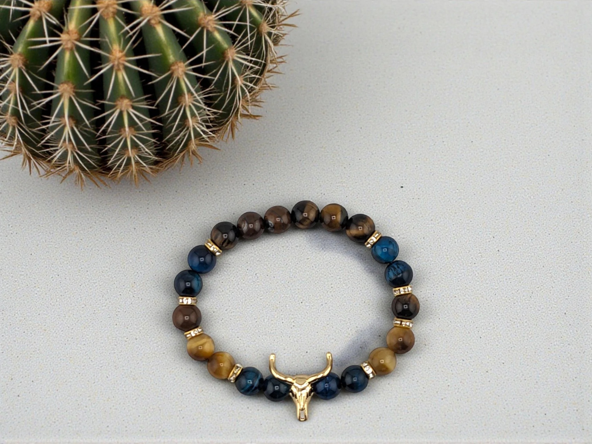 Beaded western bracelet with gold, brown and dark turquoise tiger eye separated by rhinestone spacers