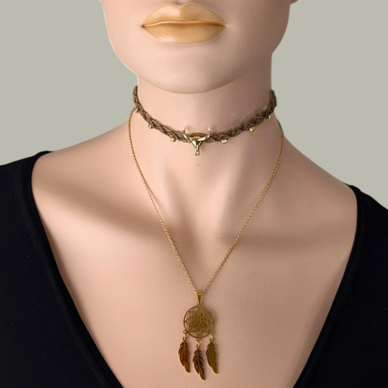 gold stainless steel dreamcatcher necklace layered with bull skull macrame choker on mannequin, bust view