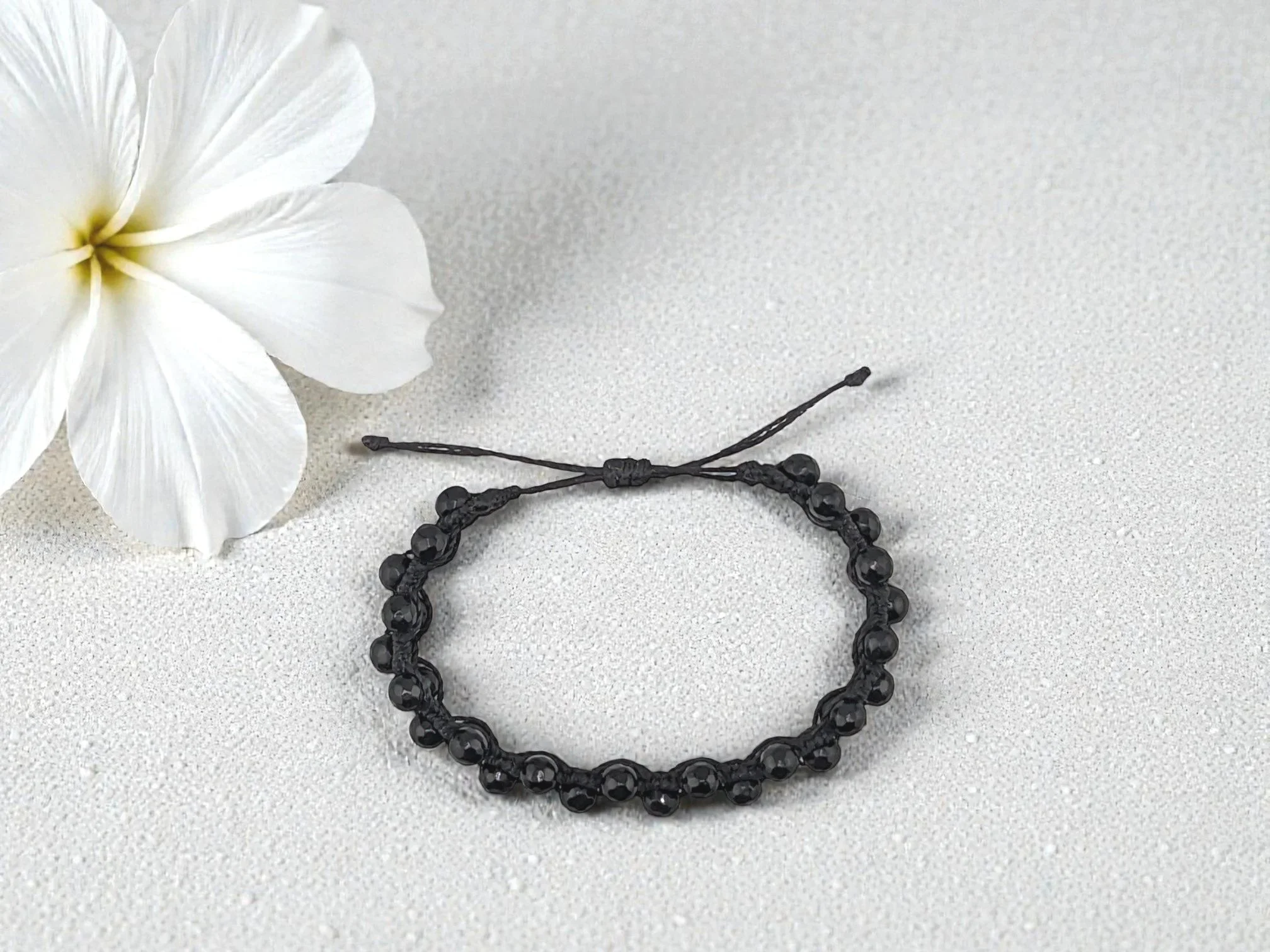 view from above of a black adjustable macramé onyx bracelet