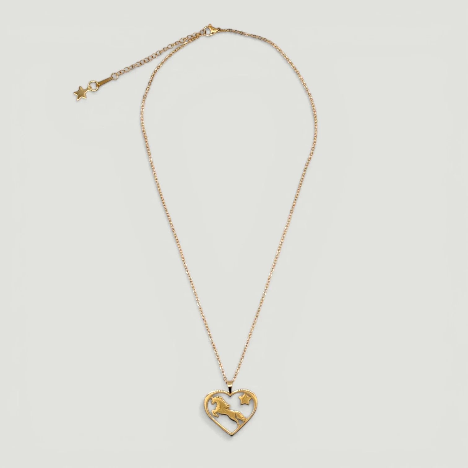 Gold stainless steel horse and heart necklace full chain flat lay