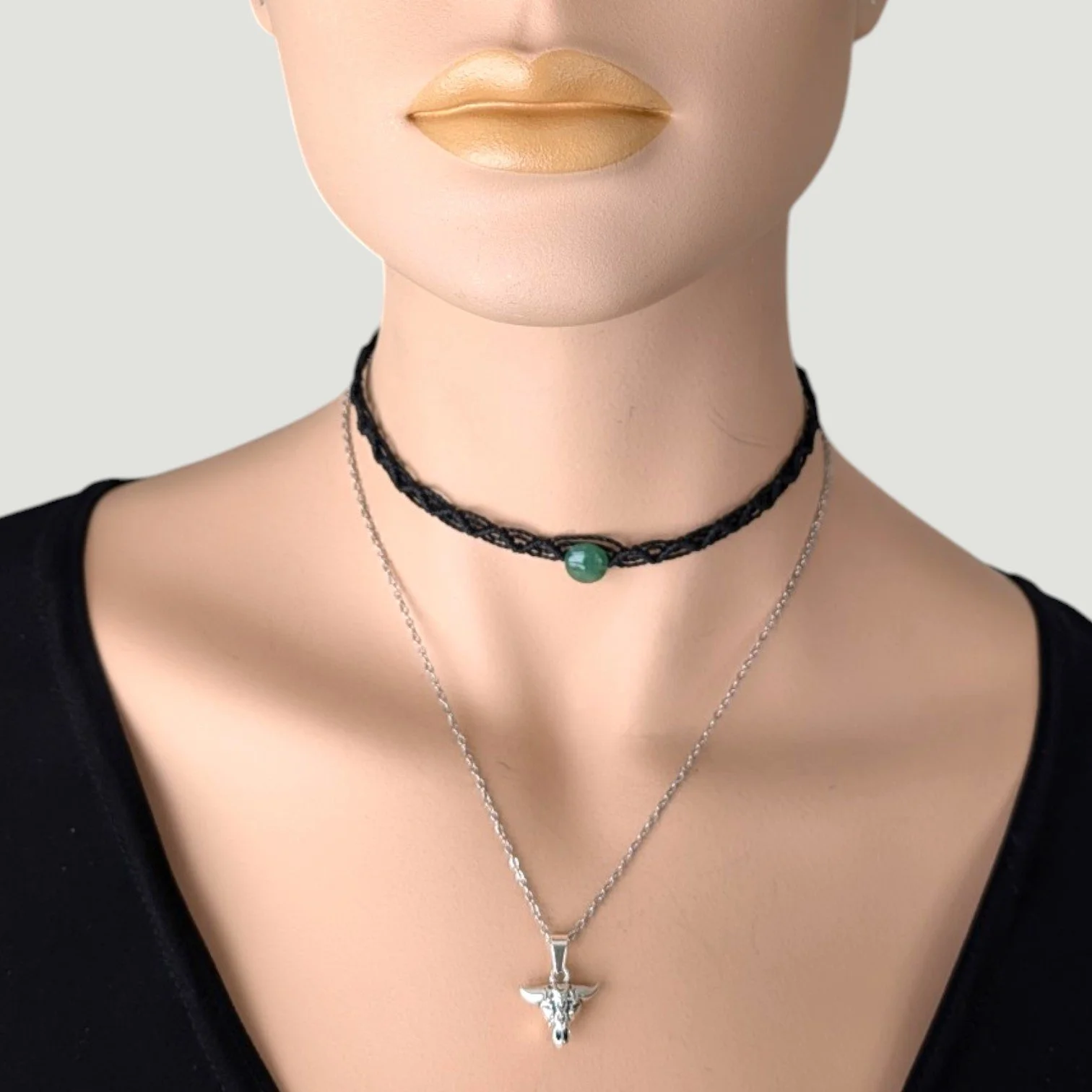 bull skull pendant on a silver stainless steel chain layered with black macrame aventurine choker on mannequin, close up bust view