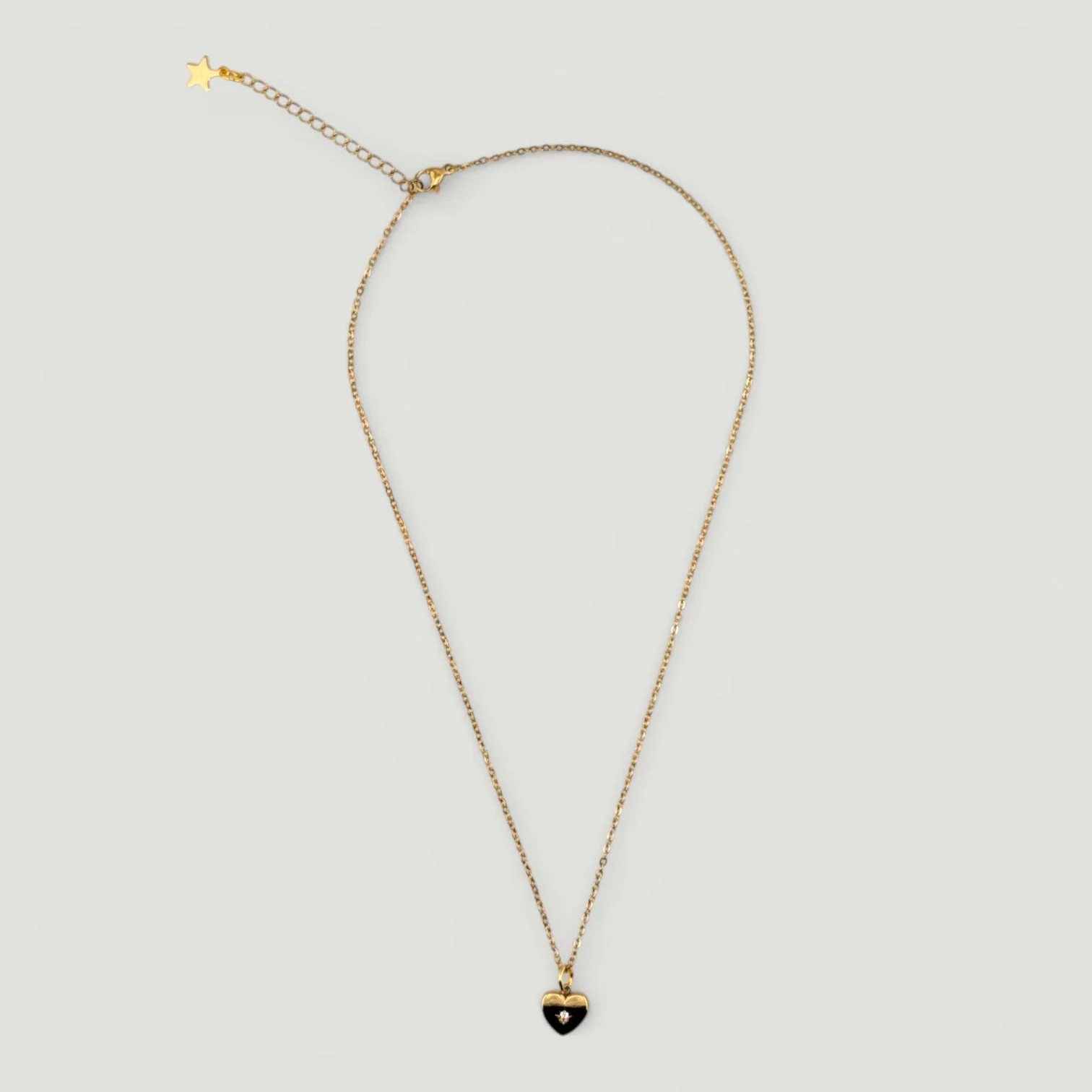 Gold stainless steel starburst heart necklace full chain, flat lay