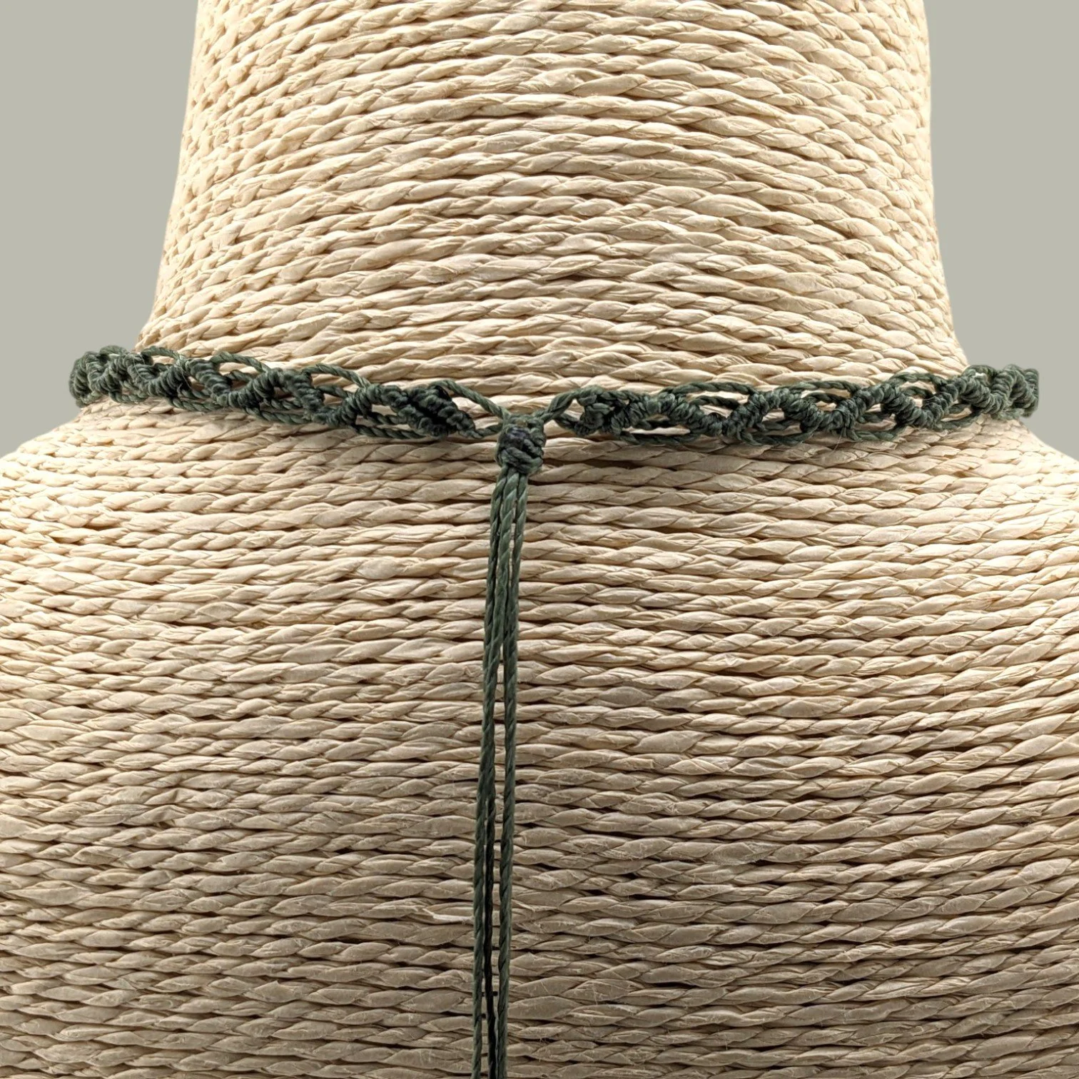 Back view of macrame woven choker showing adjustable sliding cord closure
