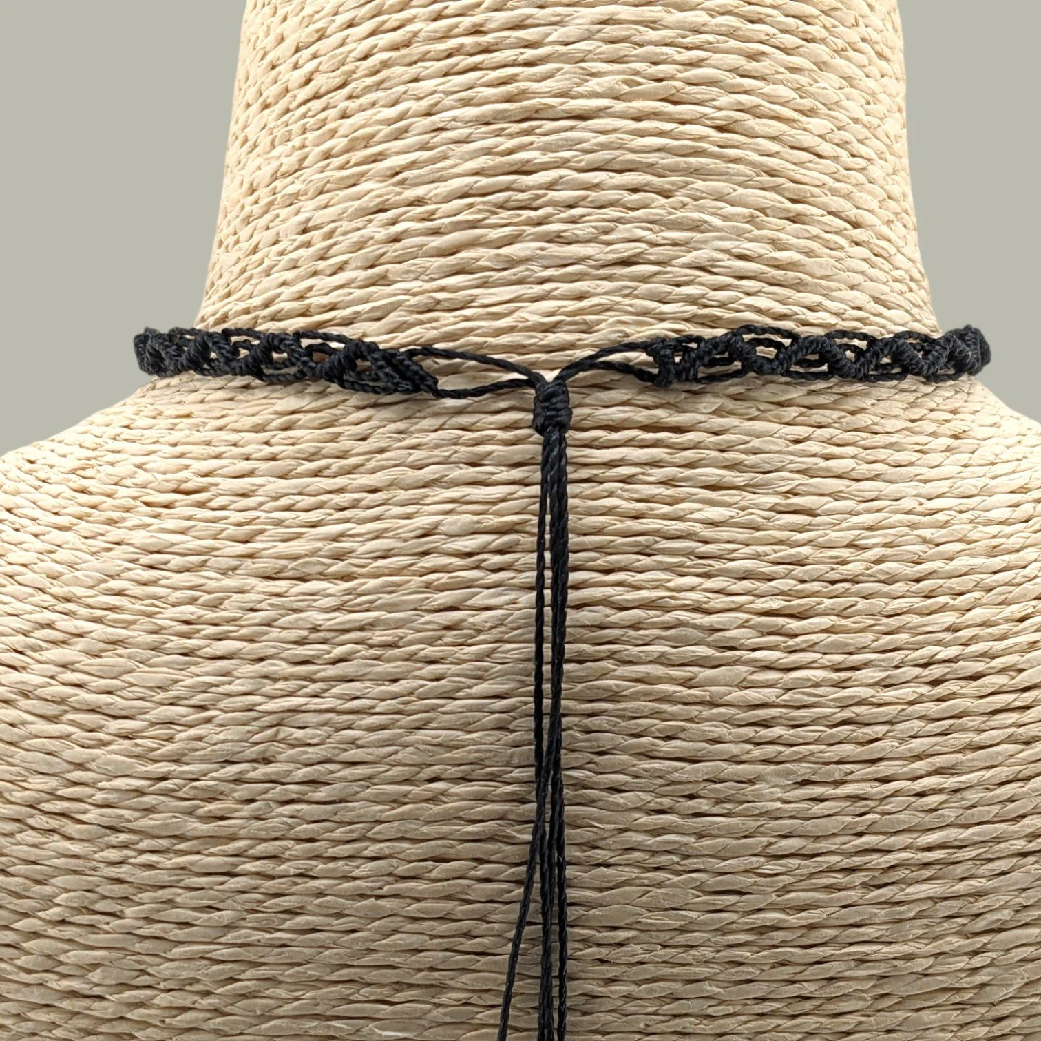 Back view of the freshwater pearl macrame choker showing the adjustable sliding knot closure