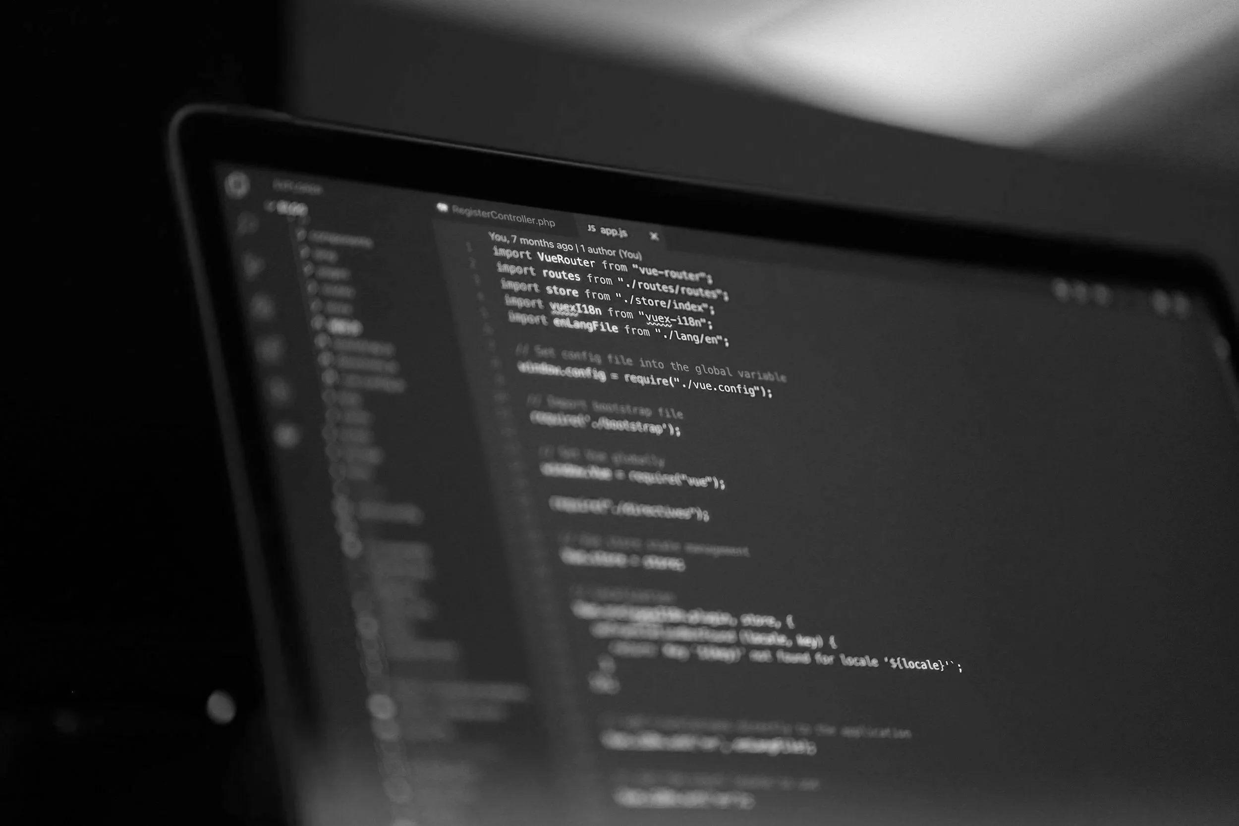 A computer screen displaying code in a dark-mode editor, with some code visible but blurry.