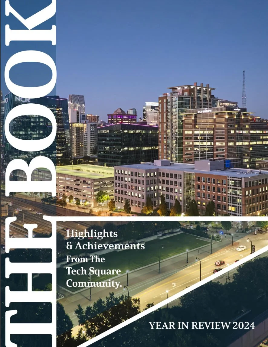 Nighttime cityscape of a downtown area with illuminated modern high-rise buildings and a busy street, featuring a large vertical sign with the word 'ROCKY' and a smaller overlay text highlighting achievements from the Tech Square community in 2024.