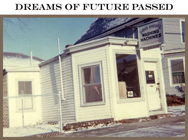 A small white building with a sign for washing machines, under a snowy sky, with the caption 'Dreams of Future Passed' at the top.