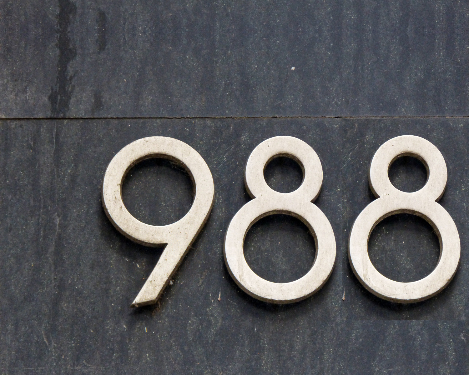 988 address numbers on a stone wall
