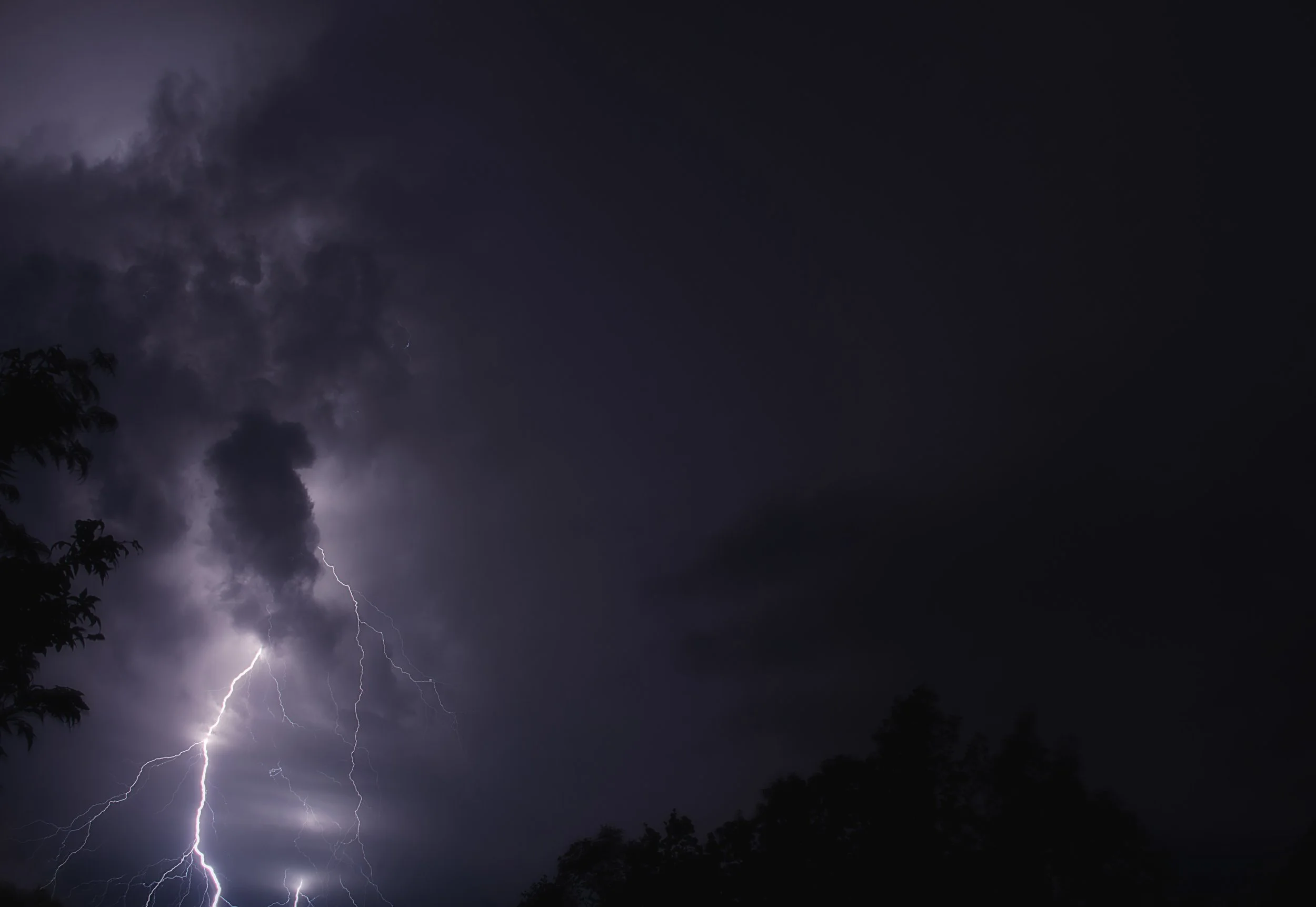 Dark stormy sky with lightning strikes.