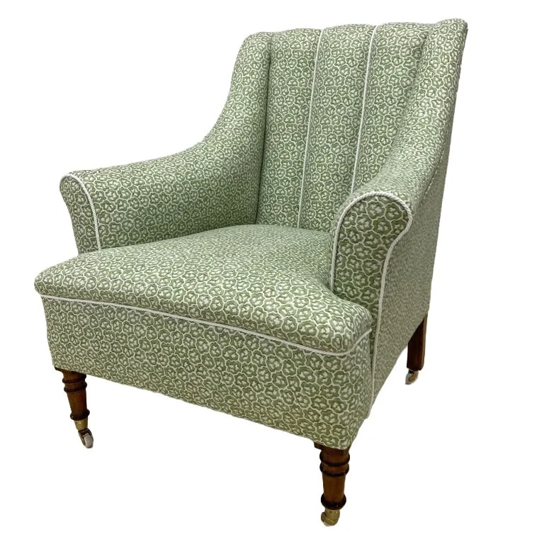 Large Edwardian armchair with fluted back and cord trim.
A complete bare frame rebuild using all traditional materials and techniques, finished in a Linwood small prints linen fabric.