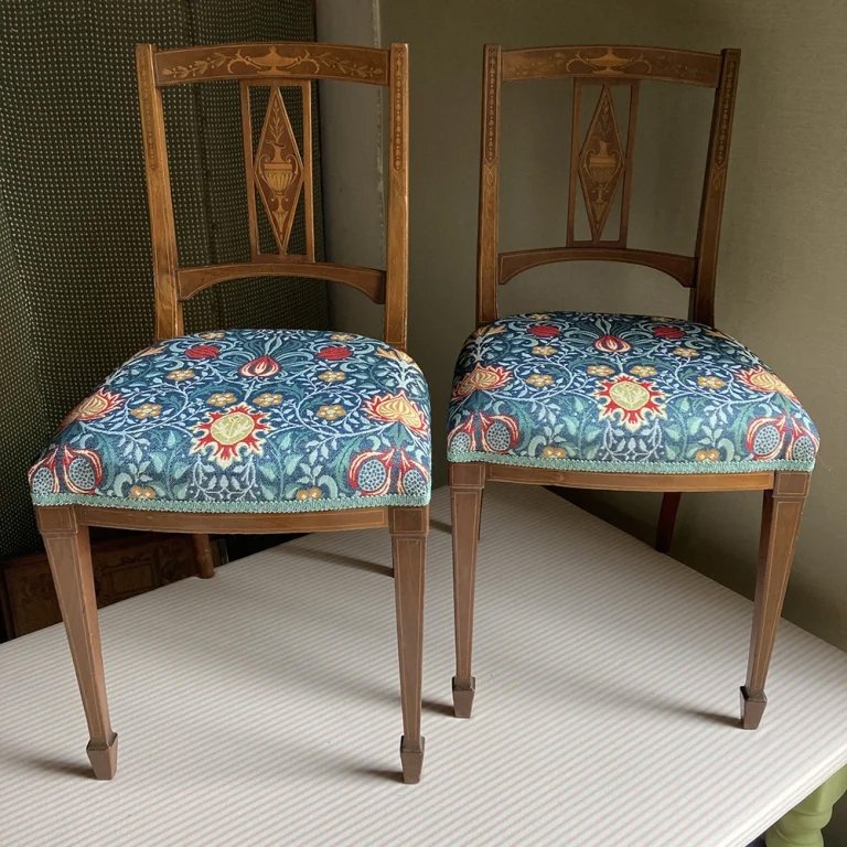 A pair of Edwardian dining chairs rebuilt and recovered with a William Morris design woven fabric supplied by the owner.