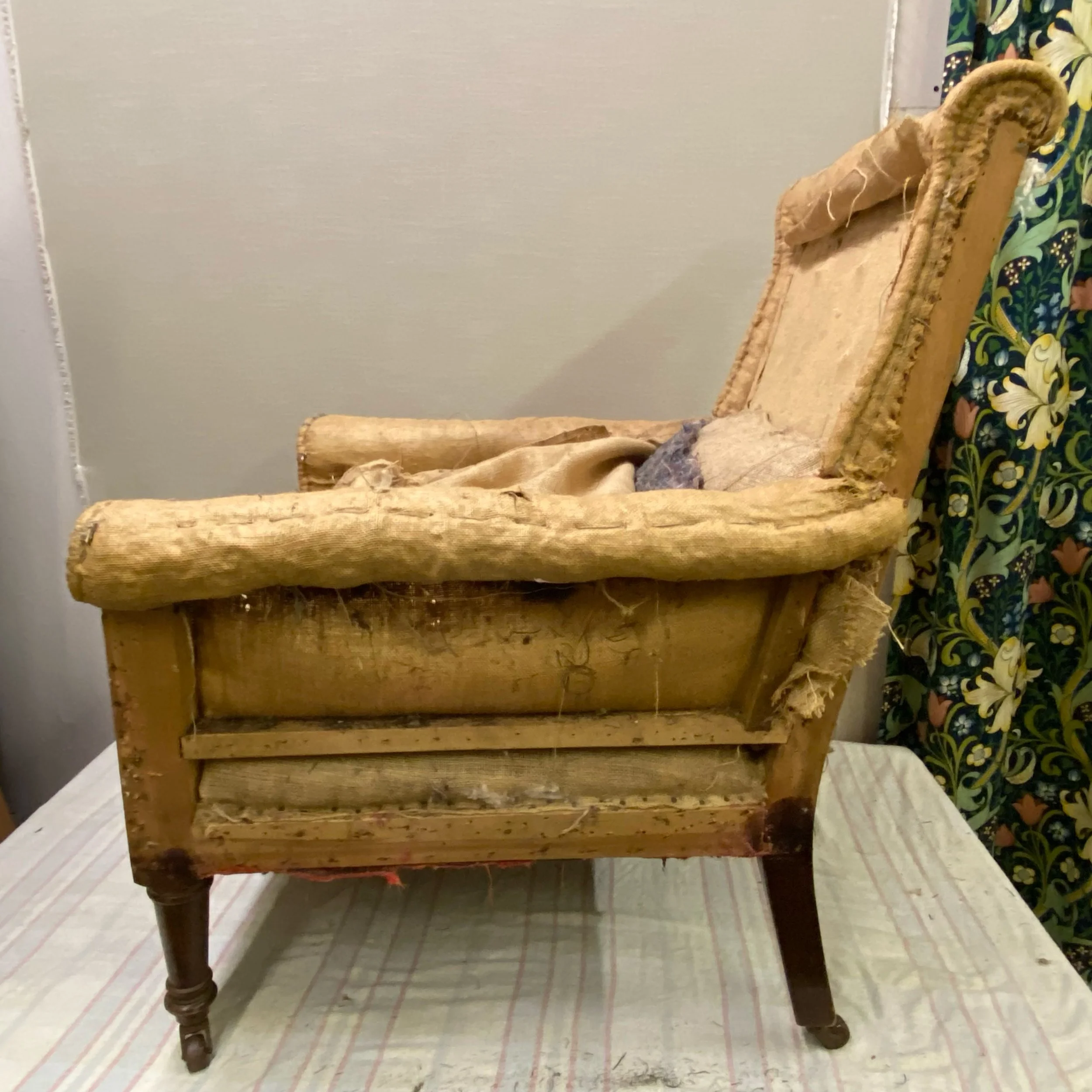 Trandtionally upholstered chiar undergoing restoration in our workshop