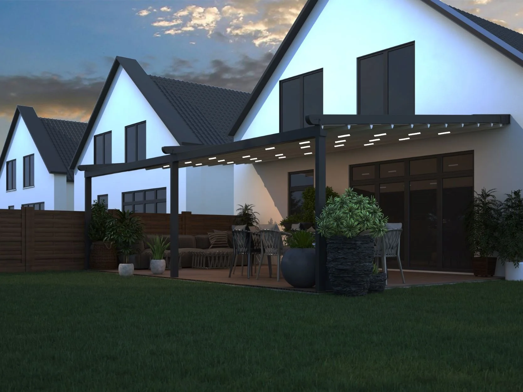 Modern house with a spacious patio and greenery, illuminated during dusk with dark sky and clouds in background.