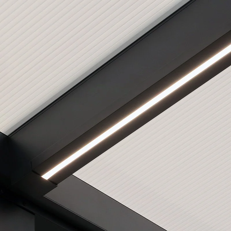 Close-up of a modern ceiling with white ribbed panels and a linear strip of LED lighting.