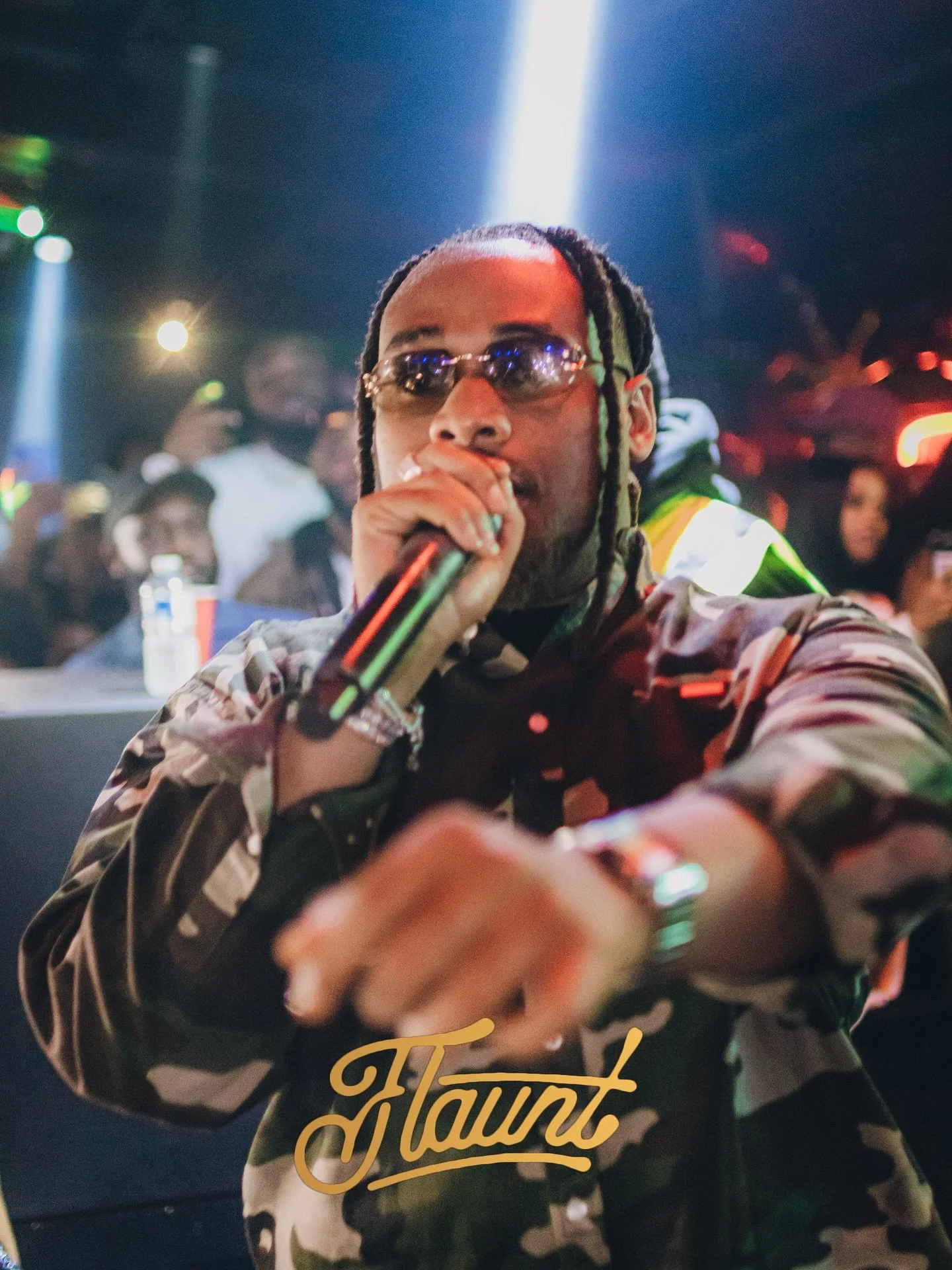 Buju on stage in a lively, colorful flaunting fit with his audience.